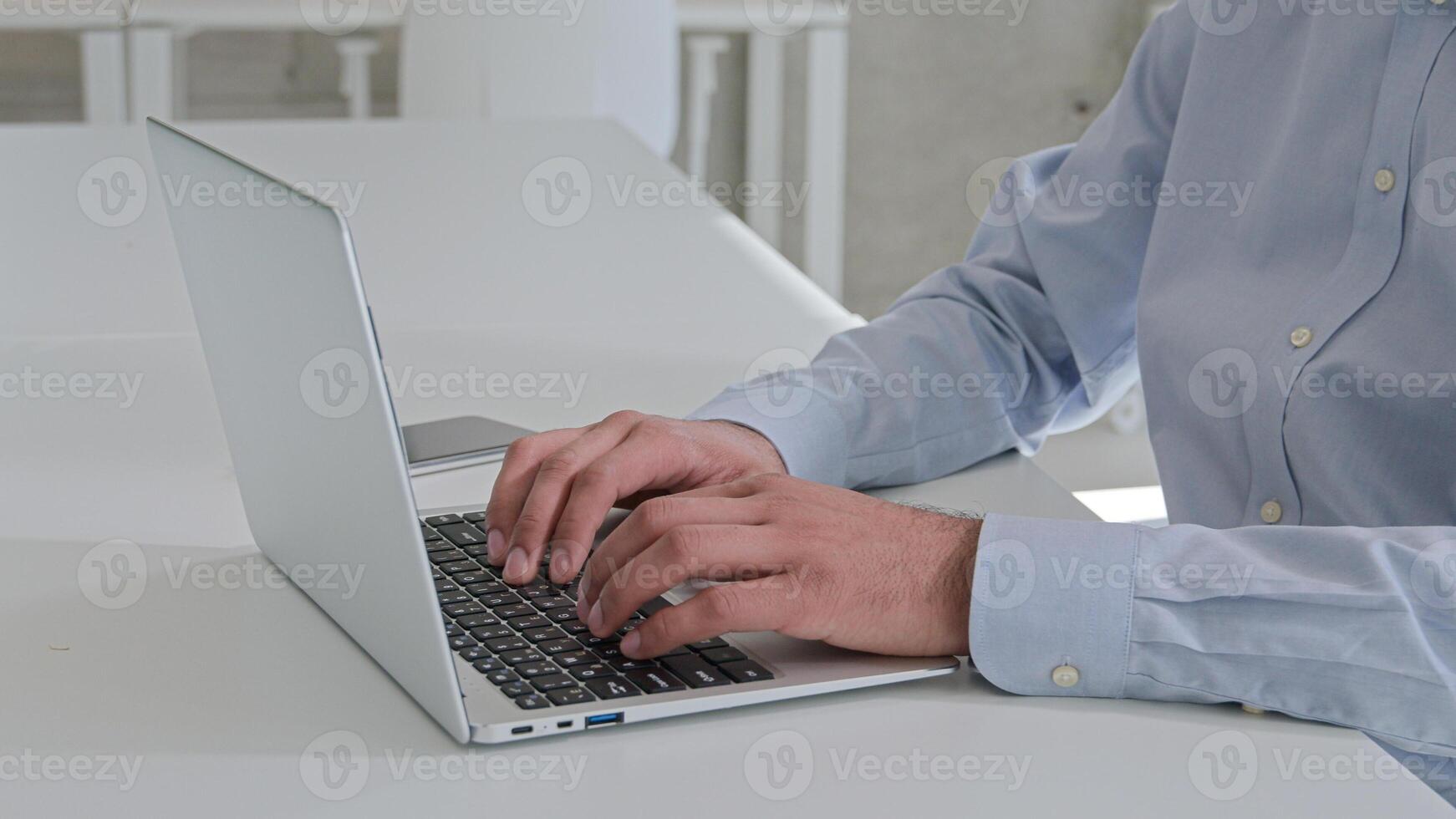 Cropped shot Indian Arabian businessman typing laptop working online programming browsing internet computer work at corporate office workplace man entrepreneur manager remote pc studying business deal photo