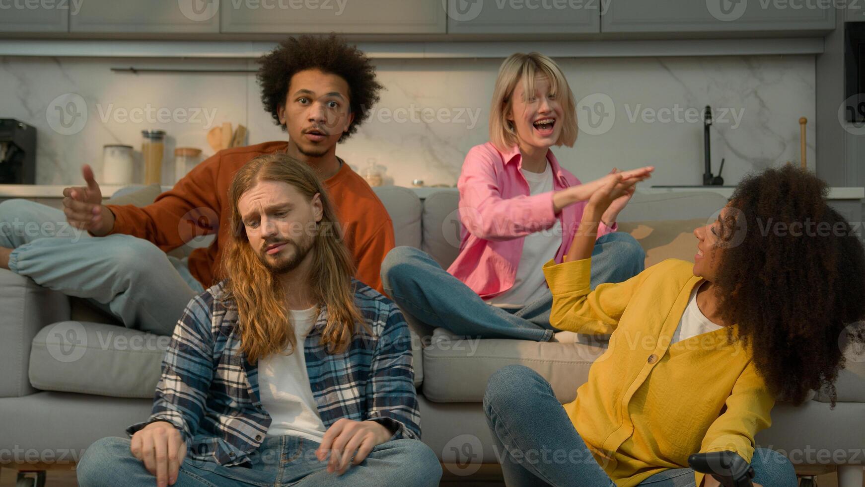 Multiracial diversity friends playing console together fun laughing Caucasian women men support game African American woman win man lost loose failure guys girls females males friendship at home photo