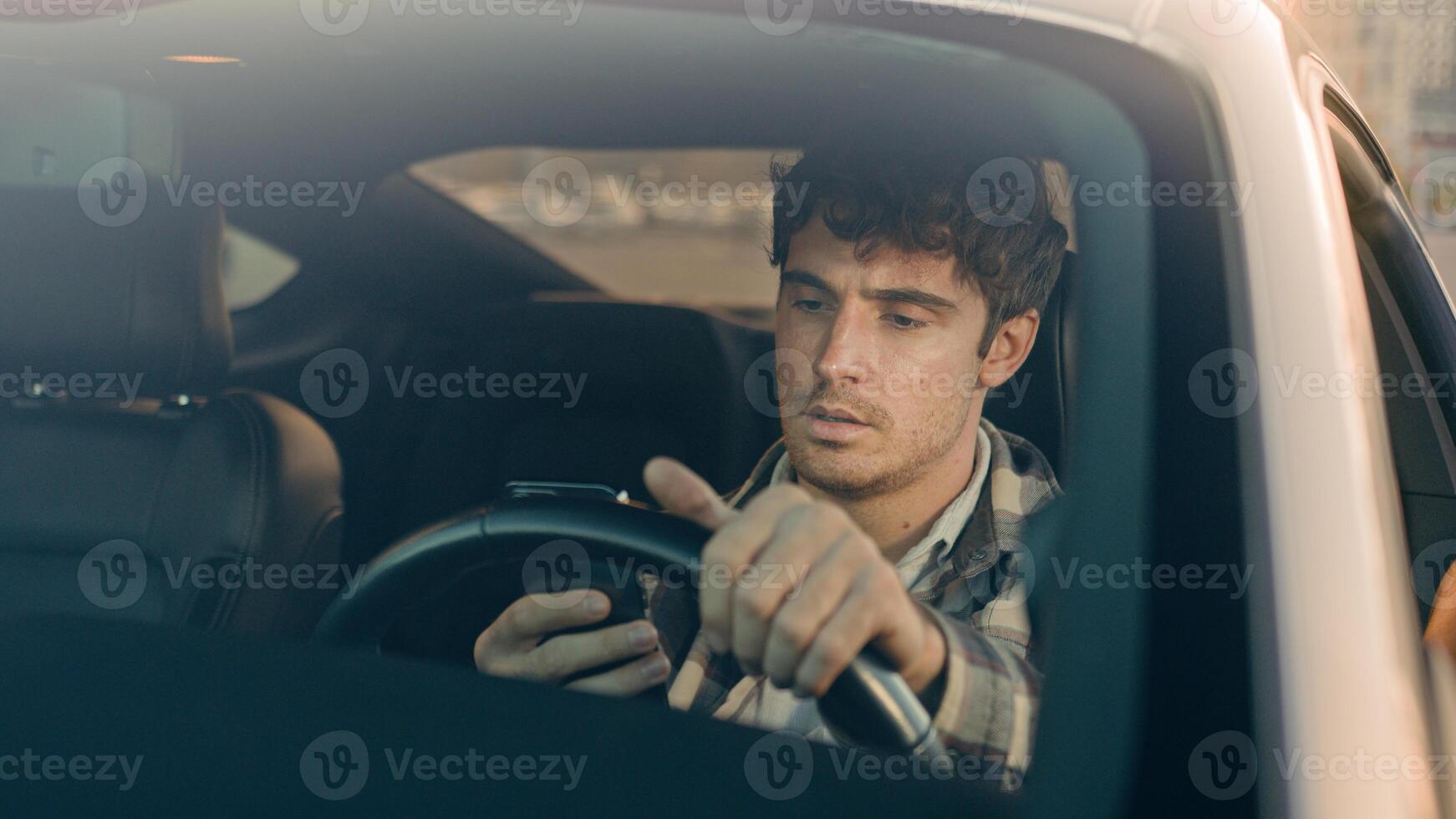Disappointed stressed sad man Caucasian auto driver businessman inside automobile car waiting in traffic jam using mobile phone read bad news upset displeased loss gps navigation road driving in city photo