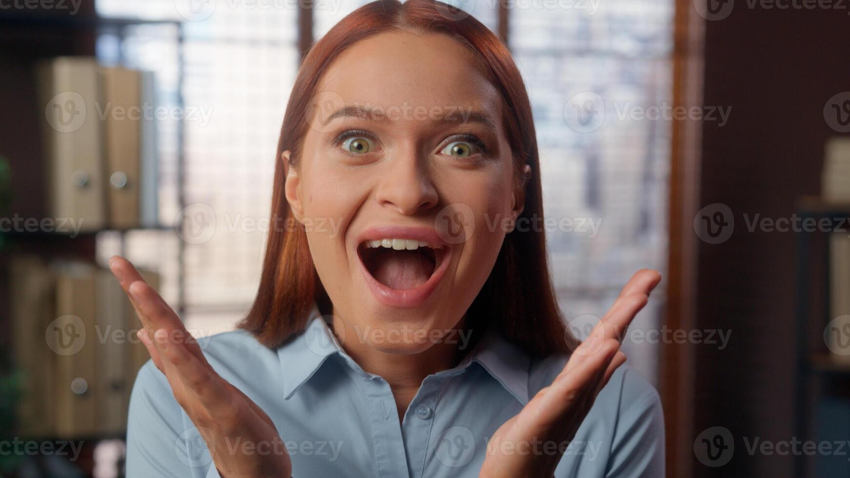 Portrait in company office amazed wonder oh my god reaction stunned big eyes open mouth shock surprise excited face student girl business woman headshot looking at camera businesswoman female lady wow photo