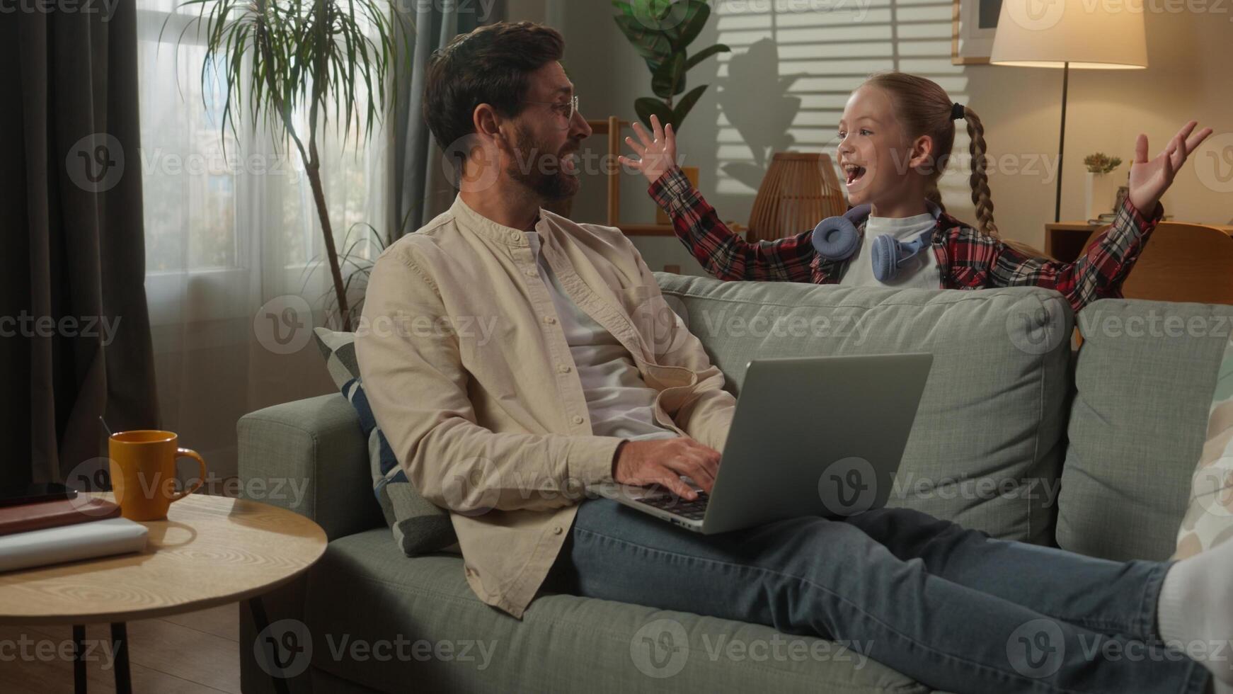 Caucasian man male freelancer user businessman at home couch father working business laptop using computer little girl daughter child kid suddenly jumping surprise scare dad playing laughing family photo