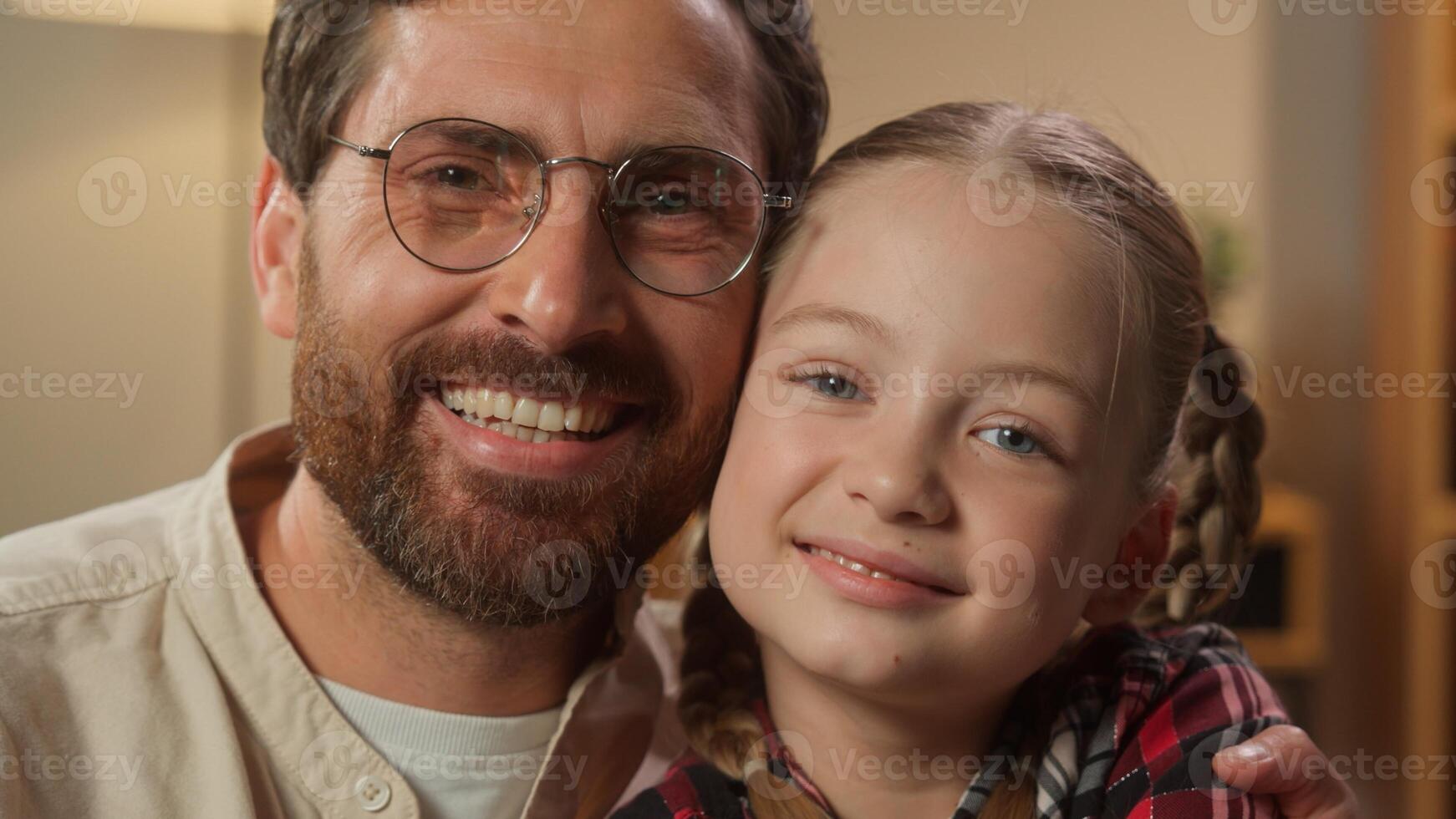 Caucasian family happy portrait Caucasian man male father dad smiling hugging cuddling little girl child kid daughter looking at camera together smile at home insurance pediatric childcare insurance photo