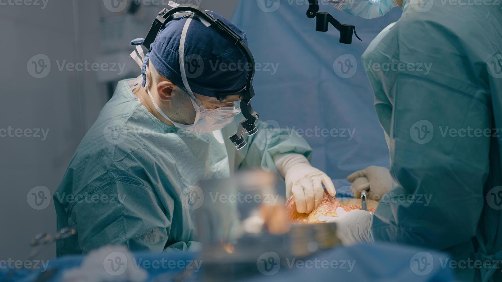 Group of surgeons men doctors physicians in medical masks process surgical operation trauma health treatment medicine aid plastic surgery with scalpel saving life patient in operating clinic hospital photo