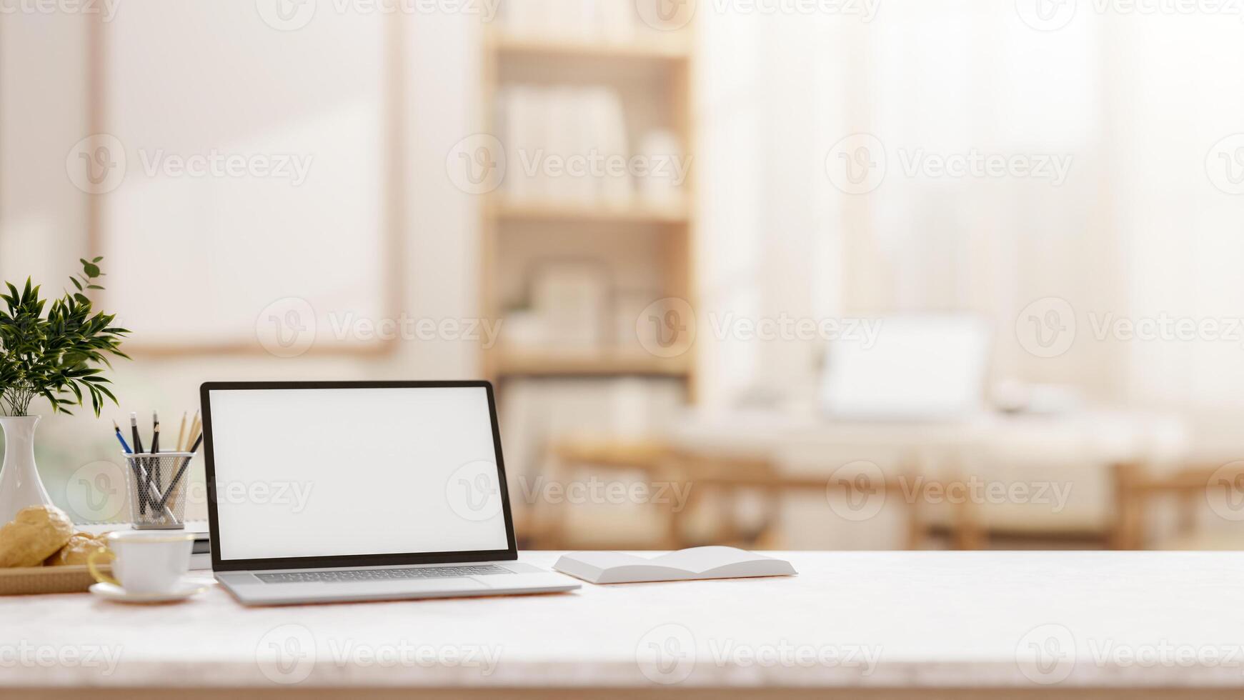 A laptop on a tabletop with a blurred background of a comfortable, minimalist room. photo