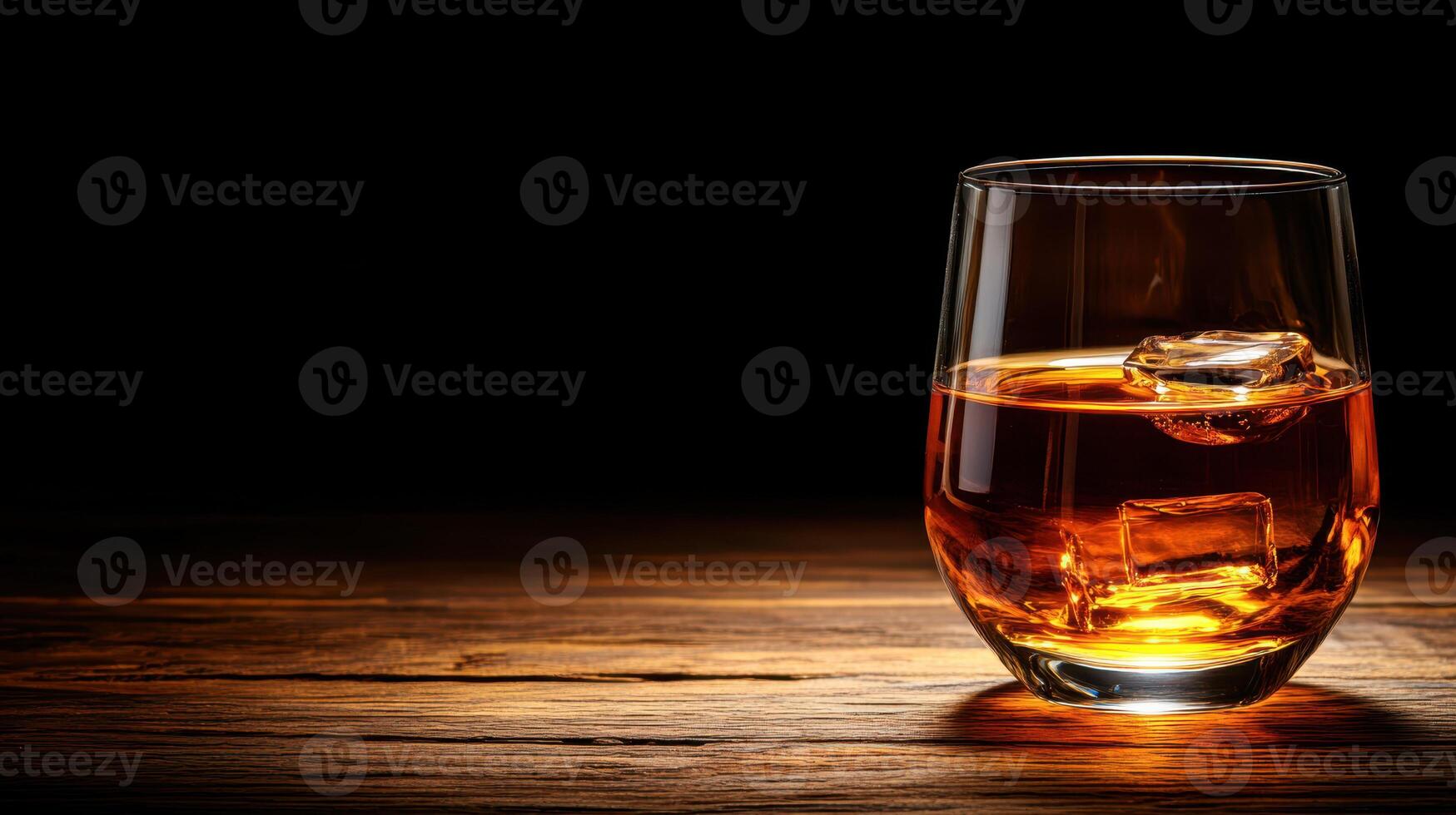 glass of whiskey with ice on wooden surface, creating warm ambiance photo