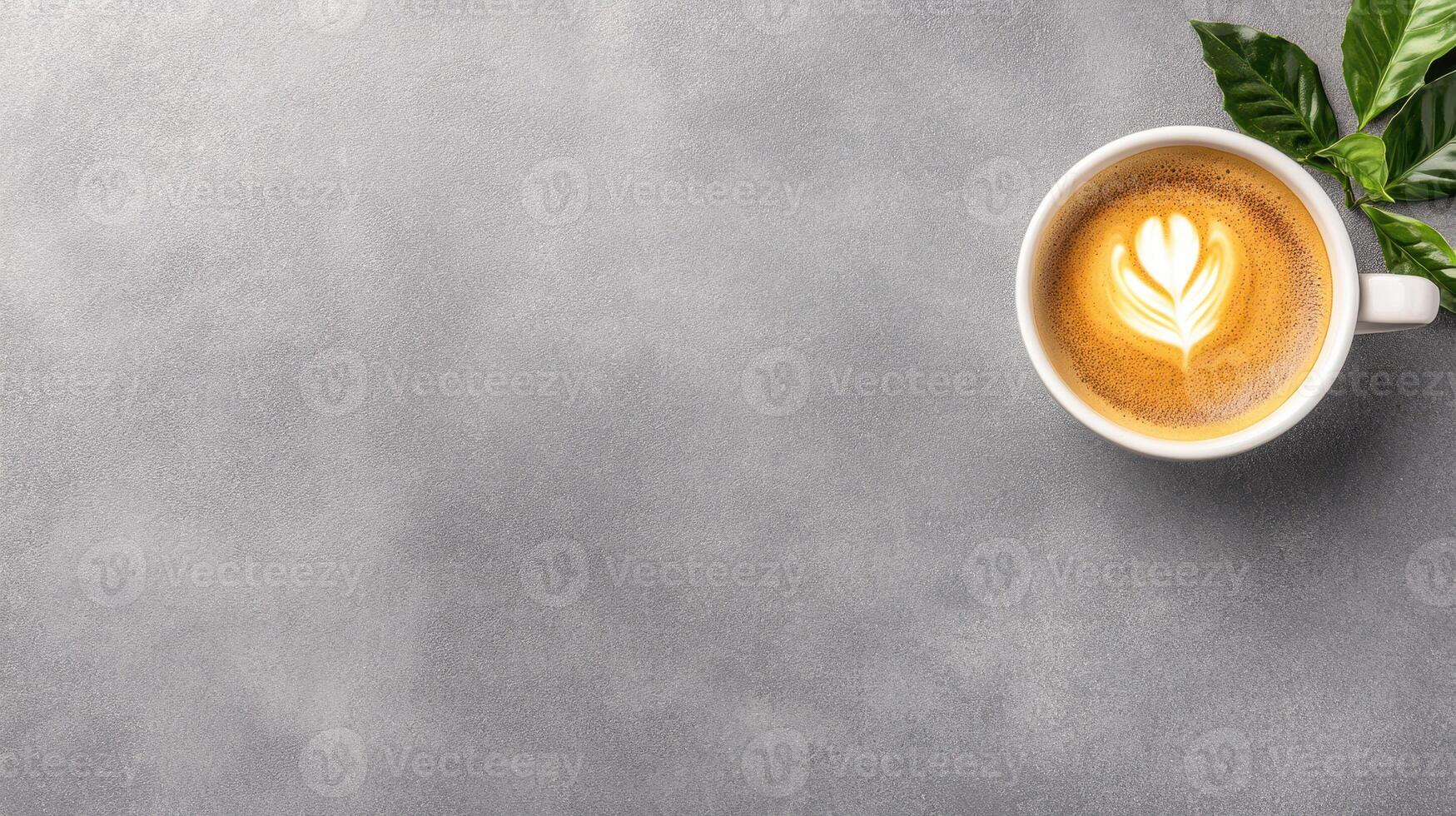 warm cup of espresso with golden crema and latte art on gray surface photo