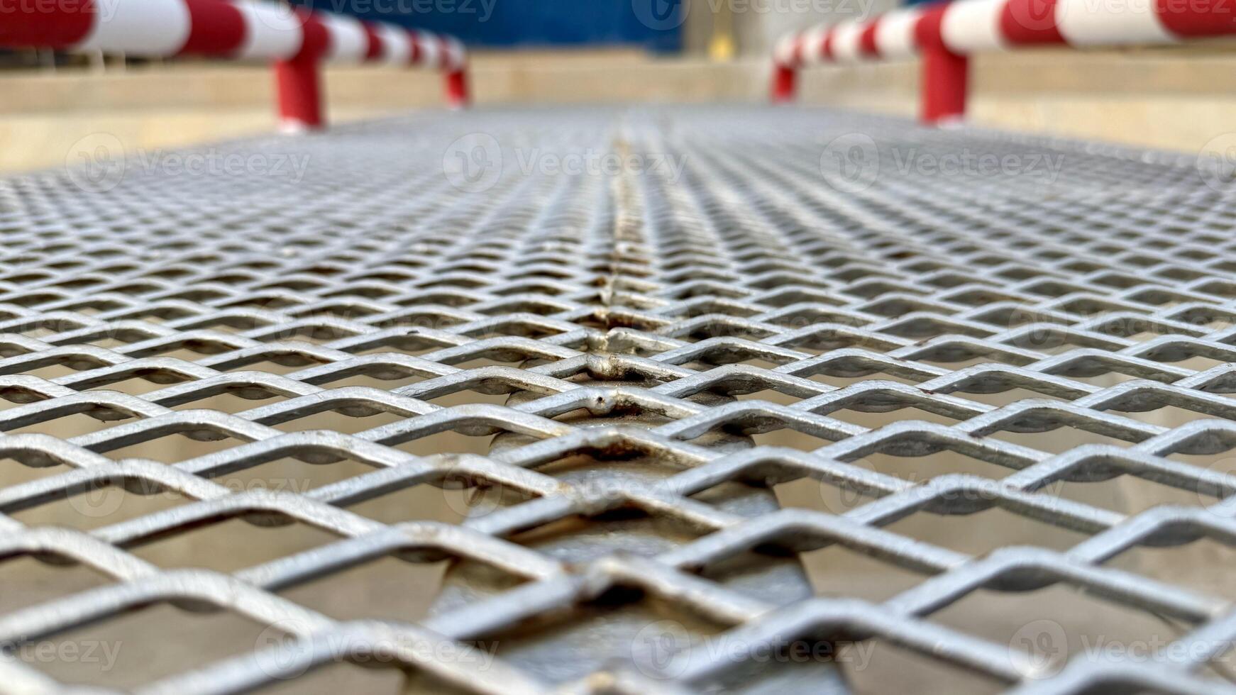 Grid of Metal An abstract photo of a metal grating with a repeating pattern of small squares, creating a sense of perspective and depth. The cool.