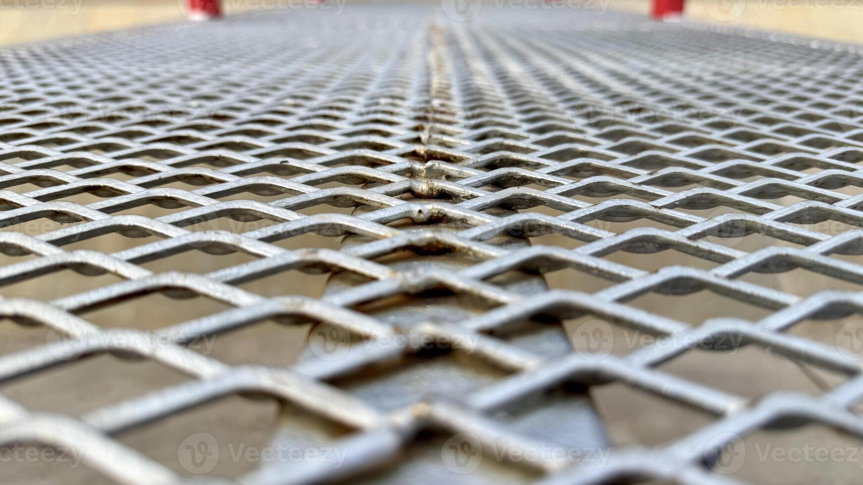 Metal Mesh Texture Close-up view of a metallic expanded metal mesh, showcasing its intricate diamond pattern and industrial aesthetic. photo