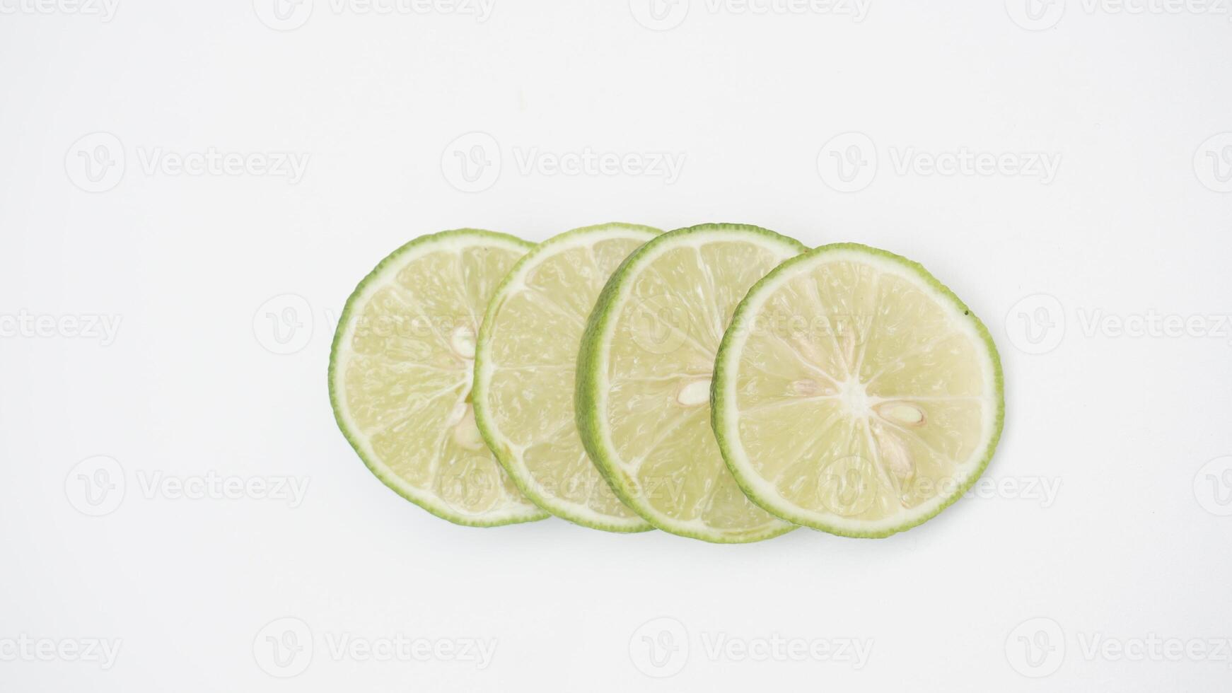 Fresh Green Lime Slices on White Background photo