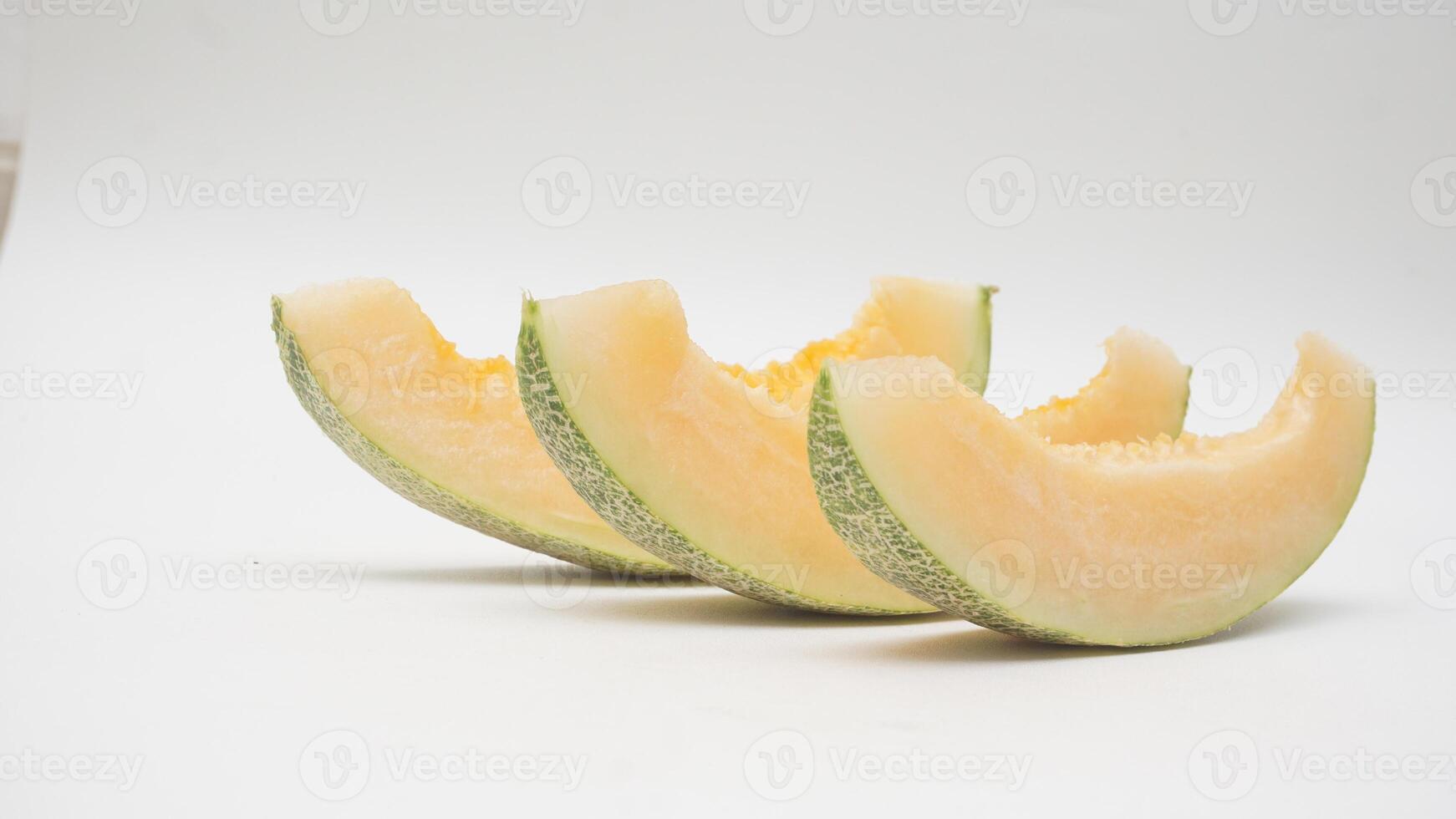 Three Slices of Cantaloupe Melon on White Background photo