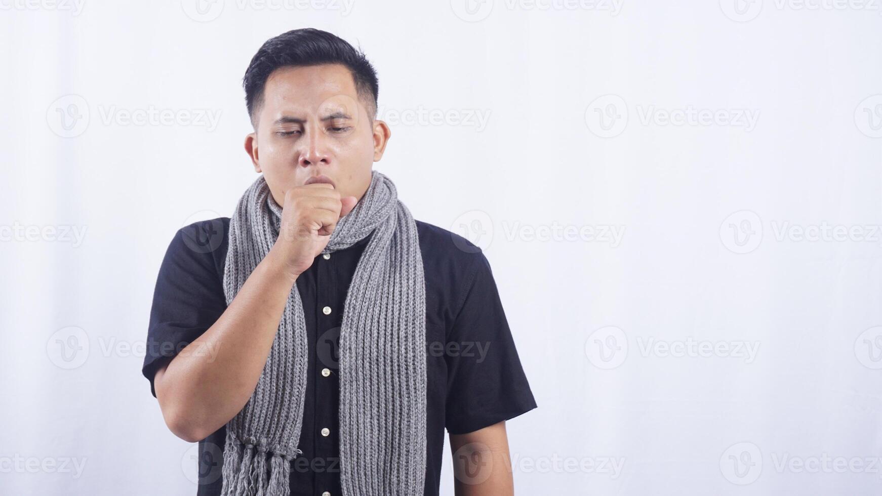 Young Asian Man Cough into His Hand on White Background photo