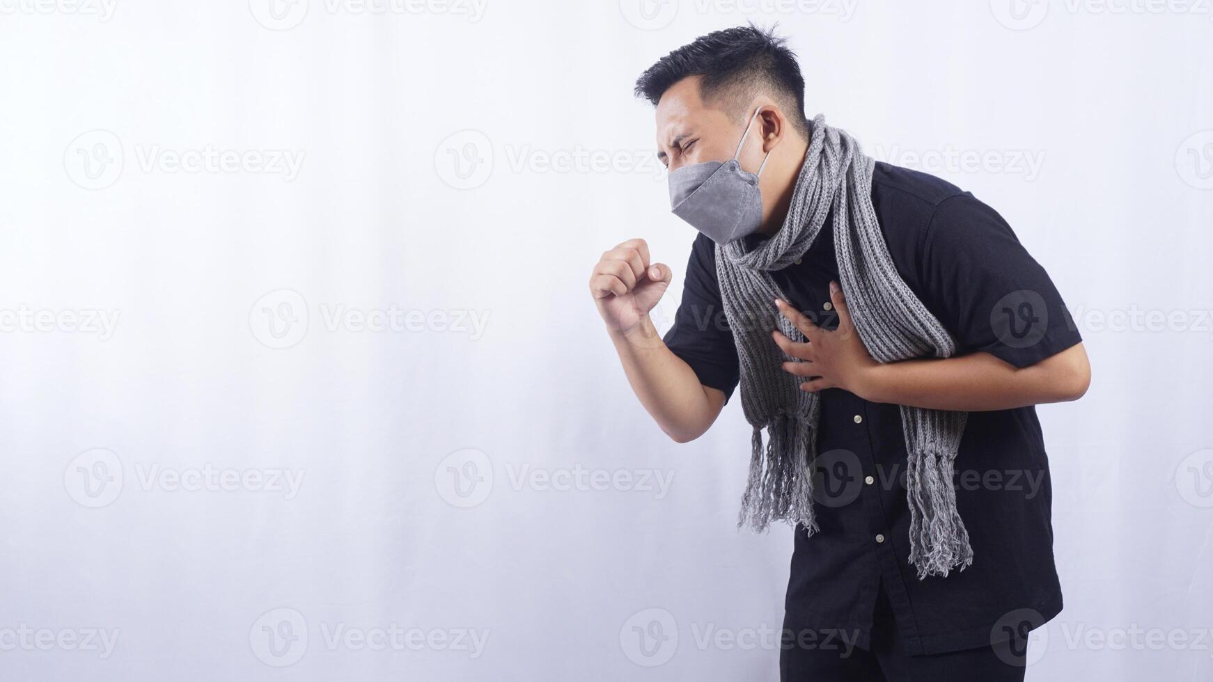 Side View of Young Man Wearing Mask Suffering from Acute Cough on White Background photo
