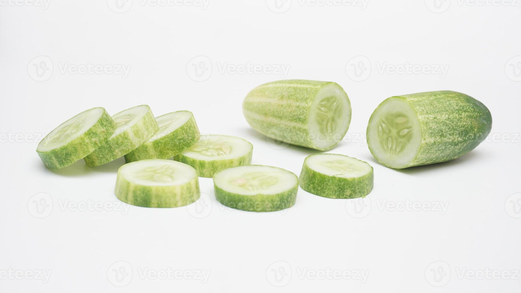 Half and Sliced Cucumber on White Background photo
