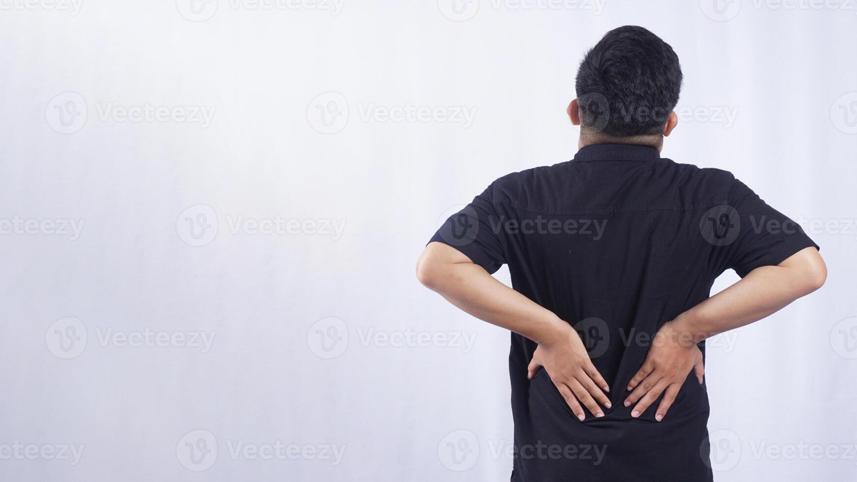 Rear View of Man with Back Pain on White Background photo