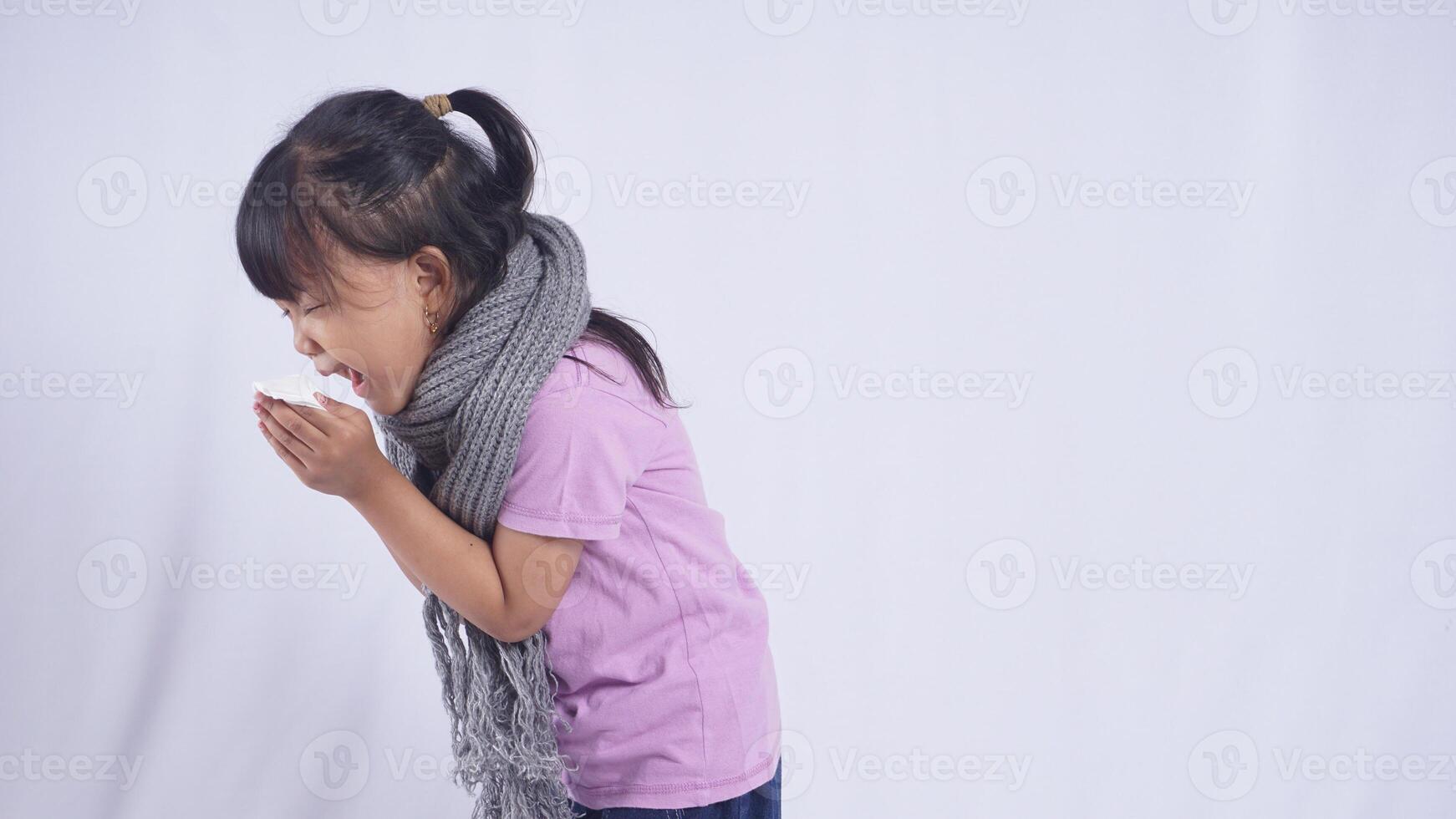 Side View of Asian Kid Girl with Scarf Suffering from Flu on White Background photo