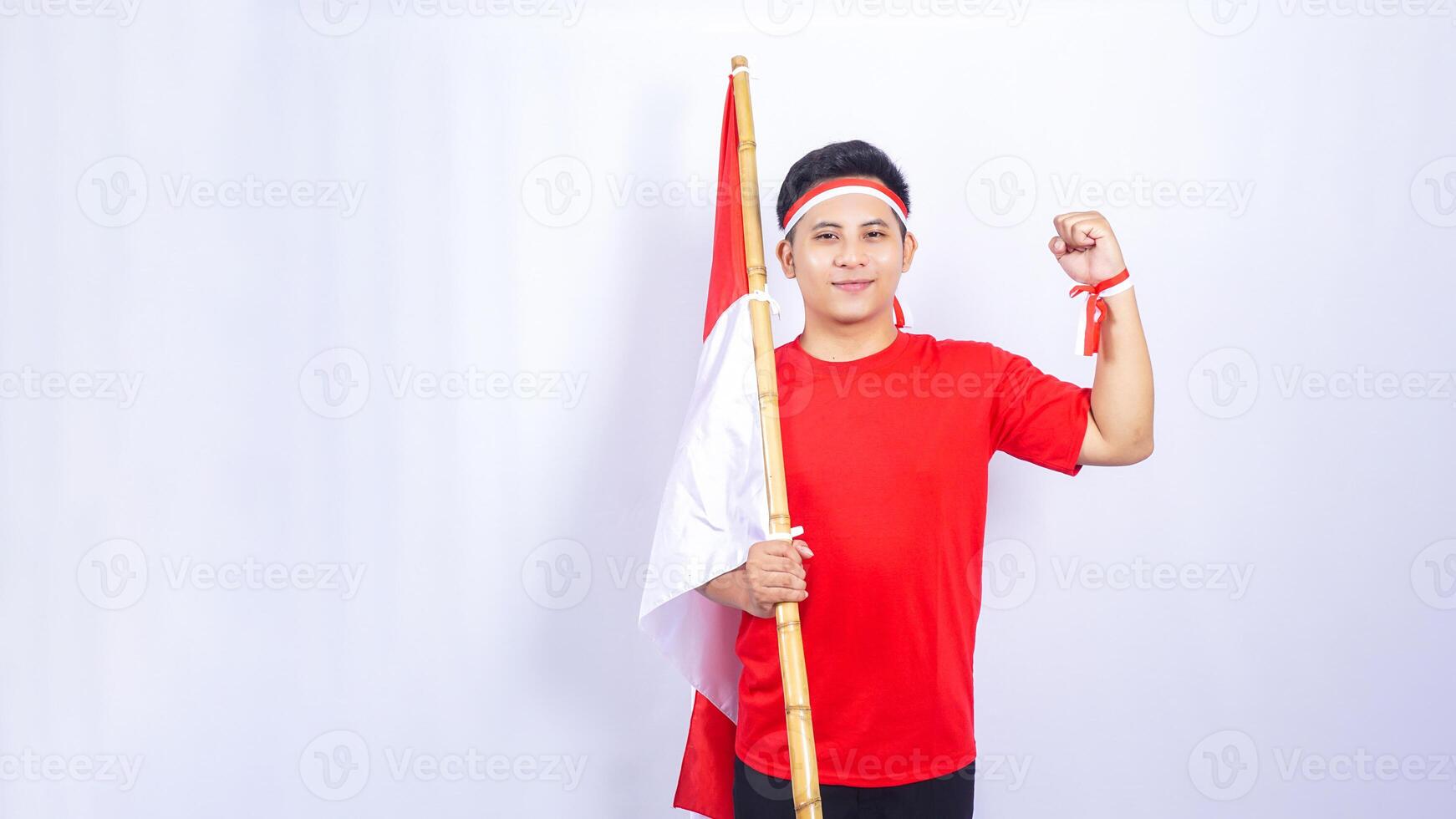 Portrait of Indonesian Man with Red and White Ribbons on His Wrist on White Background photo