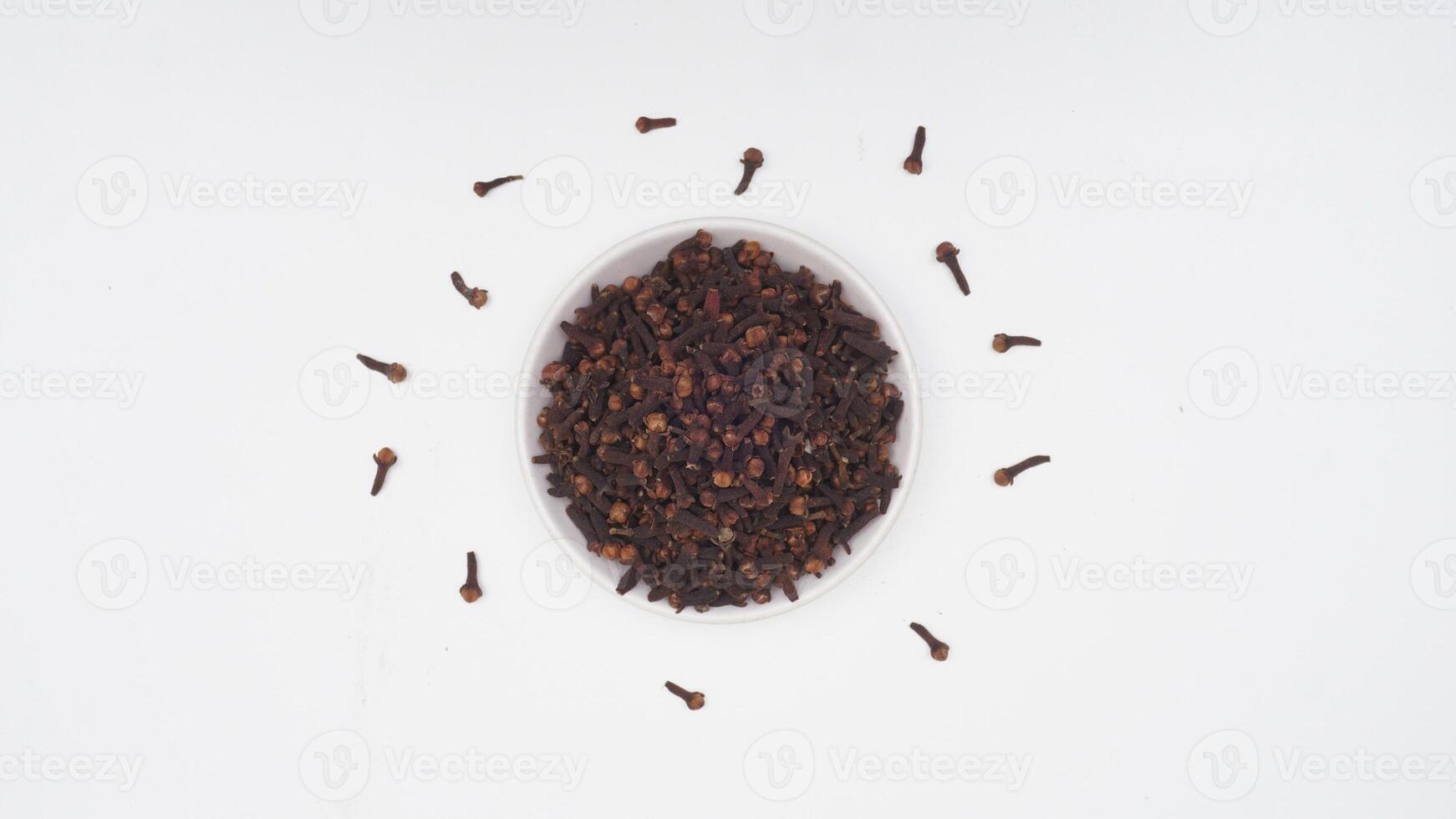 Dried Cloves Spice on Plate on White Background photo