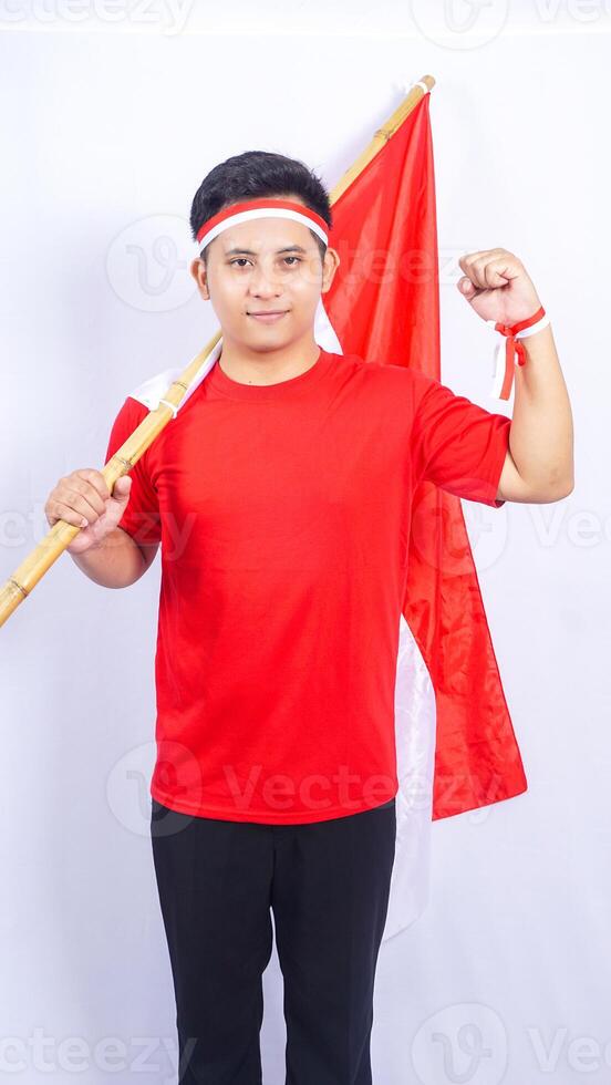 Indonesian Man with Red and White Attribute and Flag on White Background photo