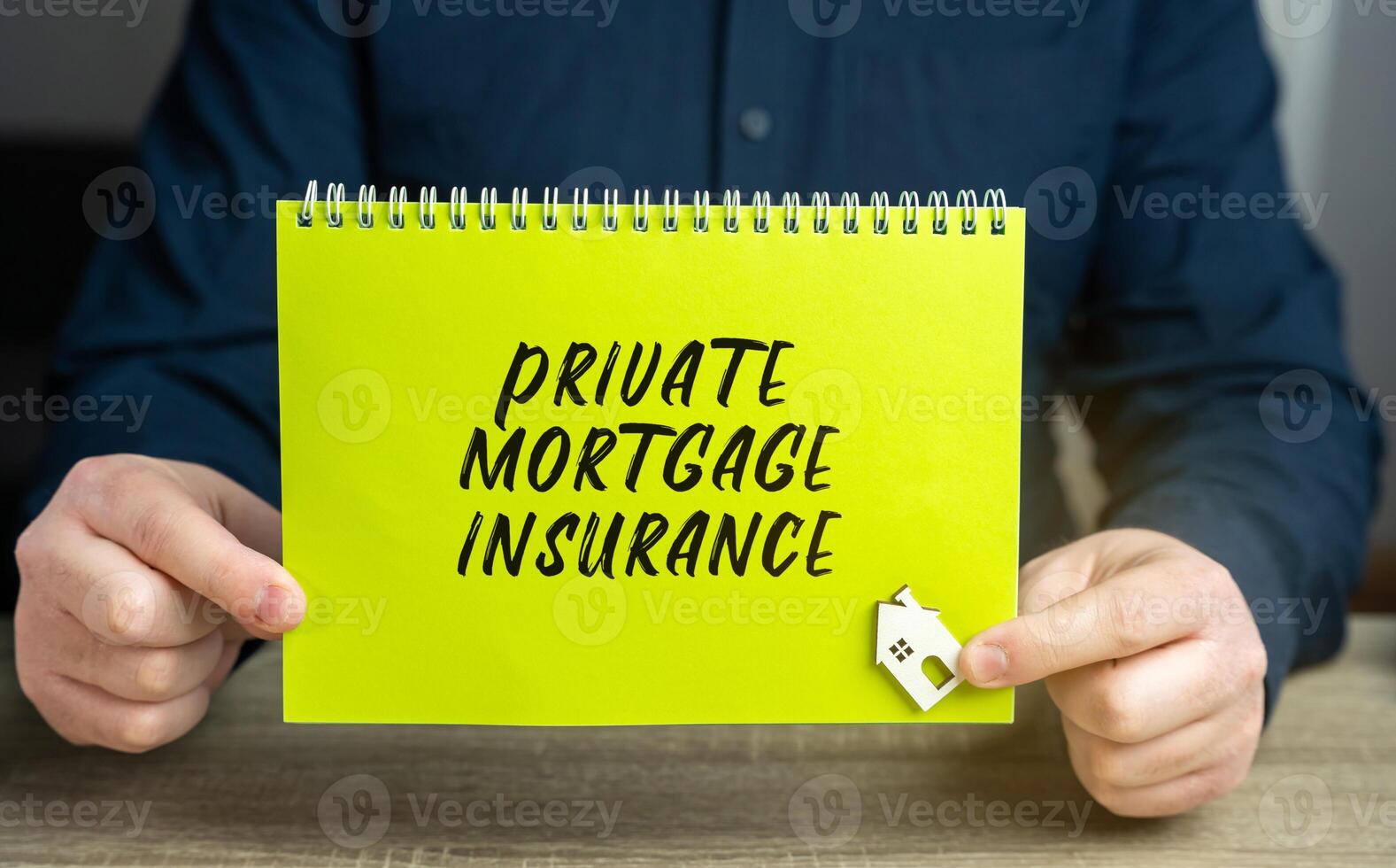 Private mortgage insurance concept. This is the mortgage type in which down payment or equity position is less than 20 percent of the property value. Business and finance. Notebook and businessman photo