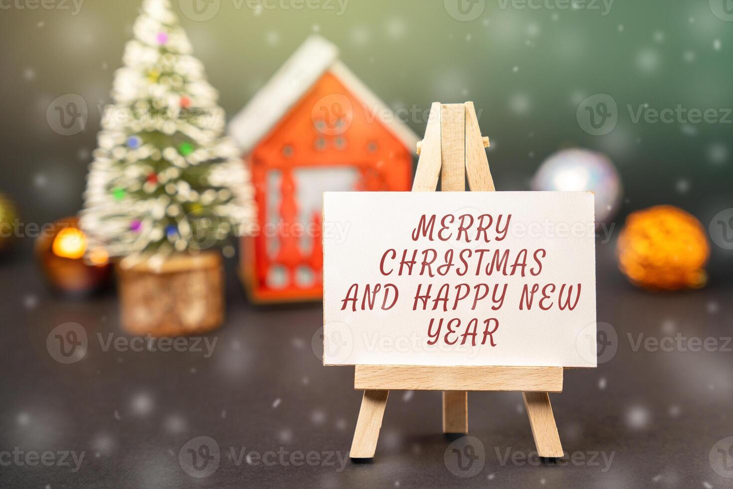 Easel with the words Happy New Year and Merry Christmas. New Year or Xmas winter holiday. Decoration, celebration. The concept of the beginning of the new year. Snow, snowfall photo