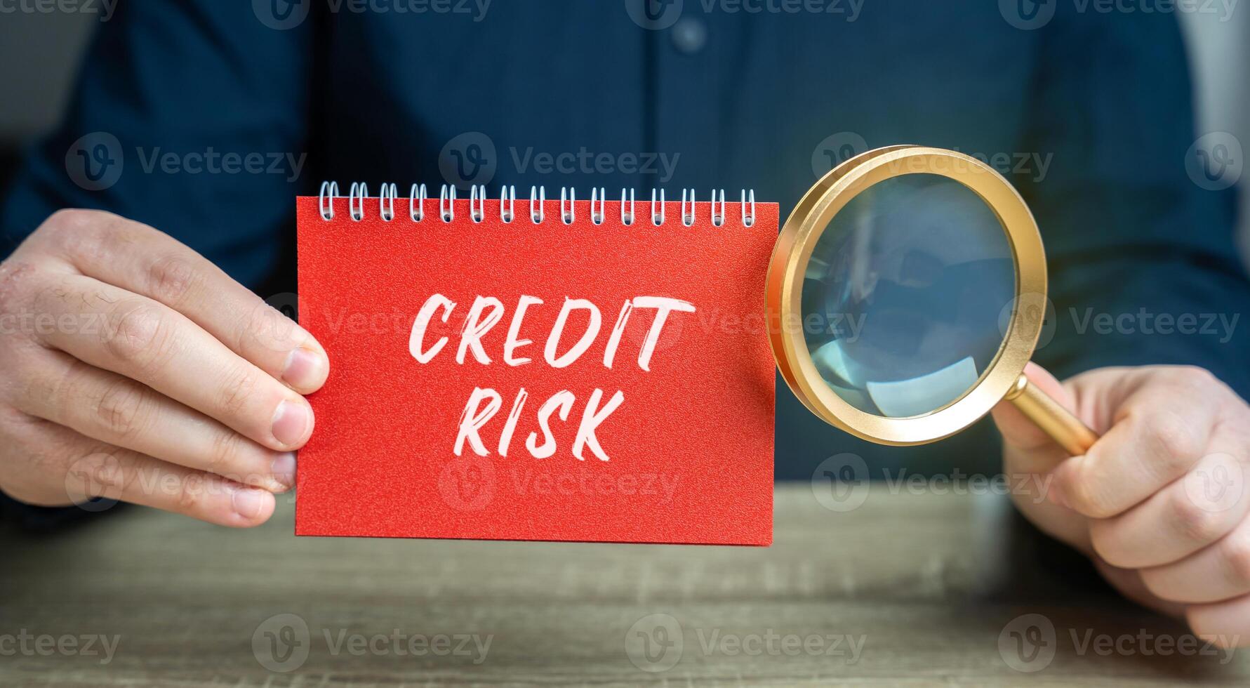 Credit risk concept. Financial loss resulting from a borrower's failure to repay a loan. Business and finance. Notepad and magnifying glass in the hands of a businessman photo