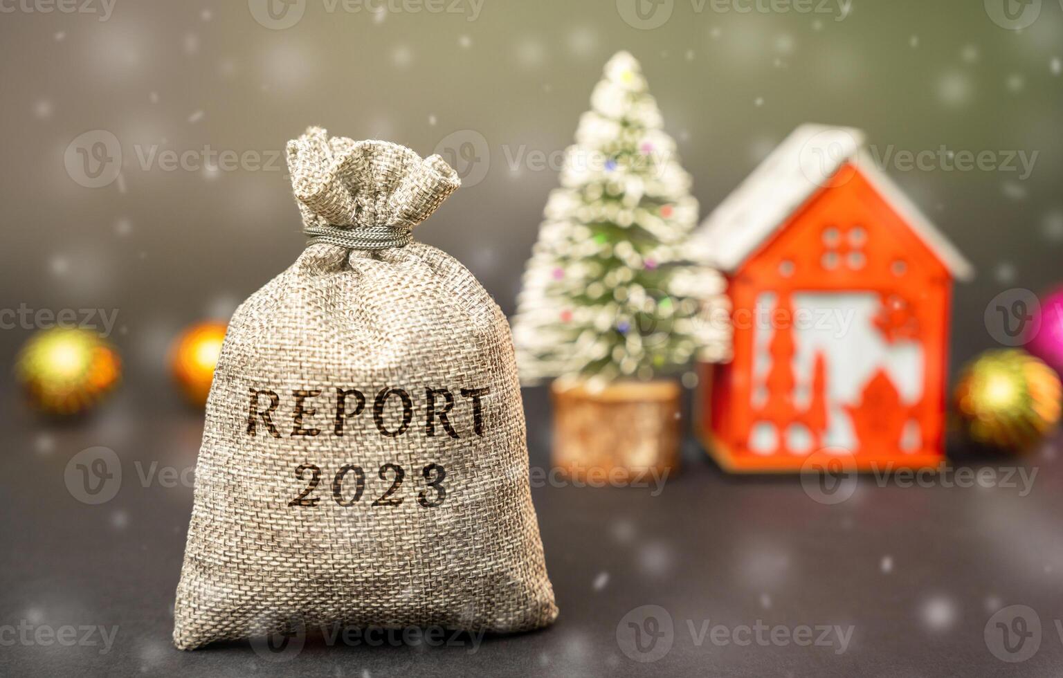 Report 2023 year concept. Business Financial Reporting Concept. Evaluation of the financial position. Balance sheet. Cash flow and audit. Money bag, Christmas tree and red house. photo