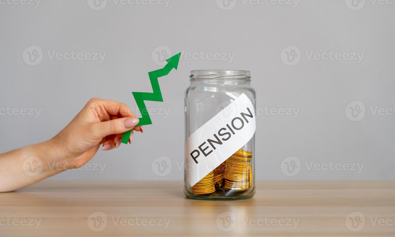 Bank of coins and the inscription Pension and green arrow up. Increase in pension payments and retirement interest rates. Business and finance concept. photo