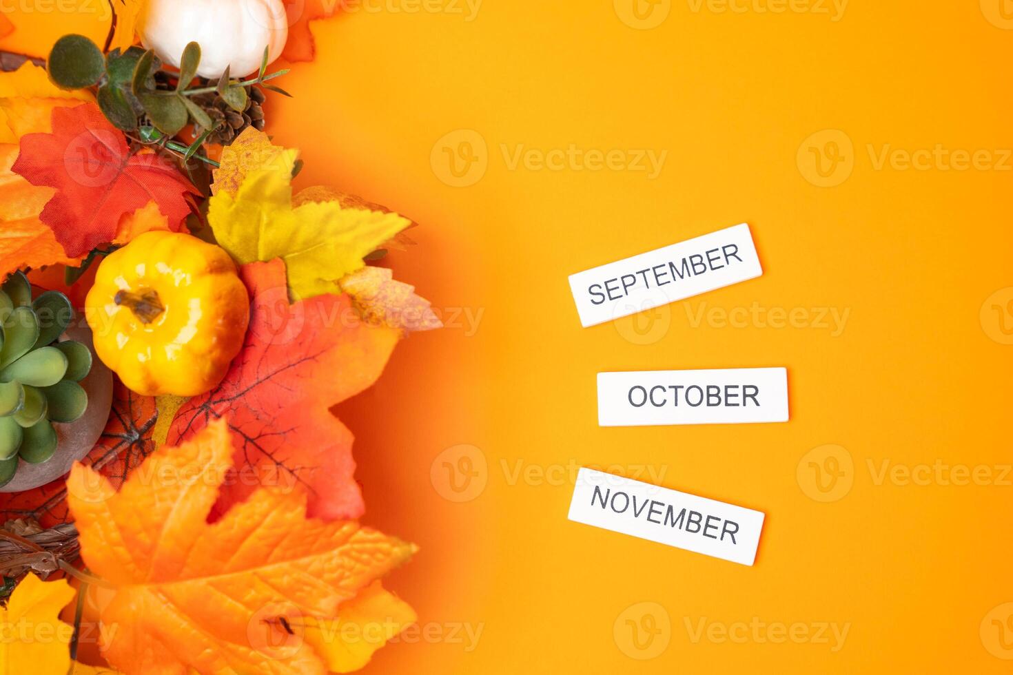Blocks September, October, November and autumn yellow leaves. Concept of beginning of new fall season. Months of fall. Decoration flat lay photo