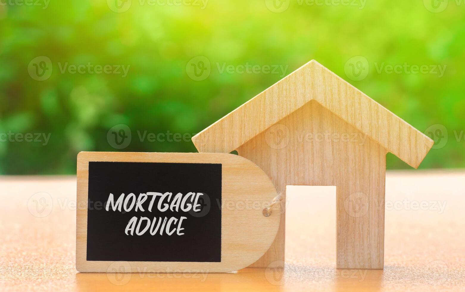 Mortgage advice concept. Professional guidance provided to help individuals choose, obtain, and manage home loans. Real estate. Wooden house with a note photo