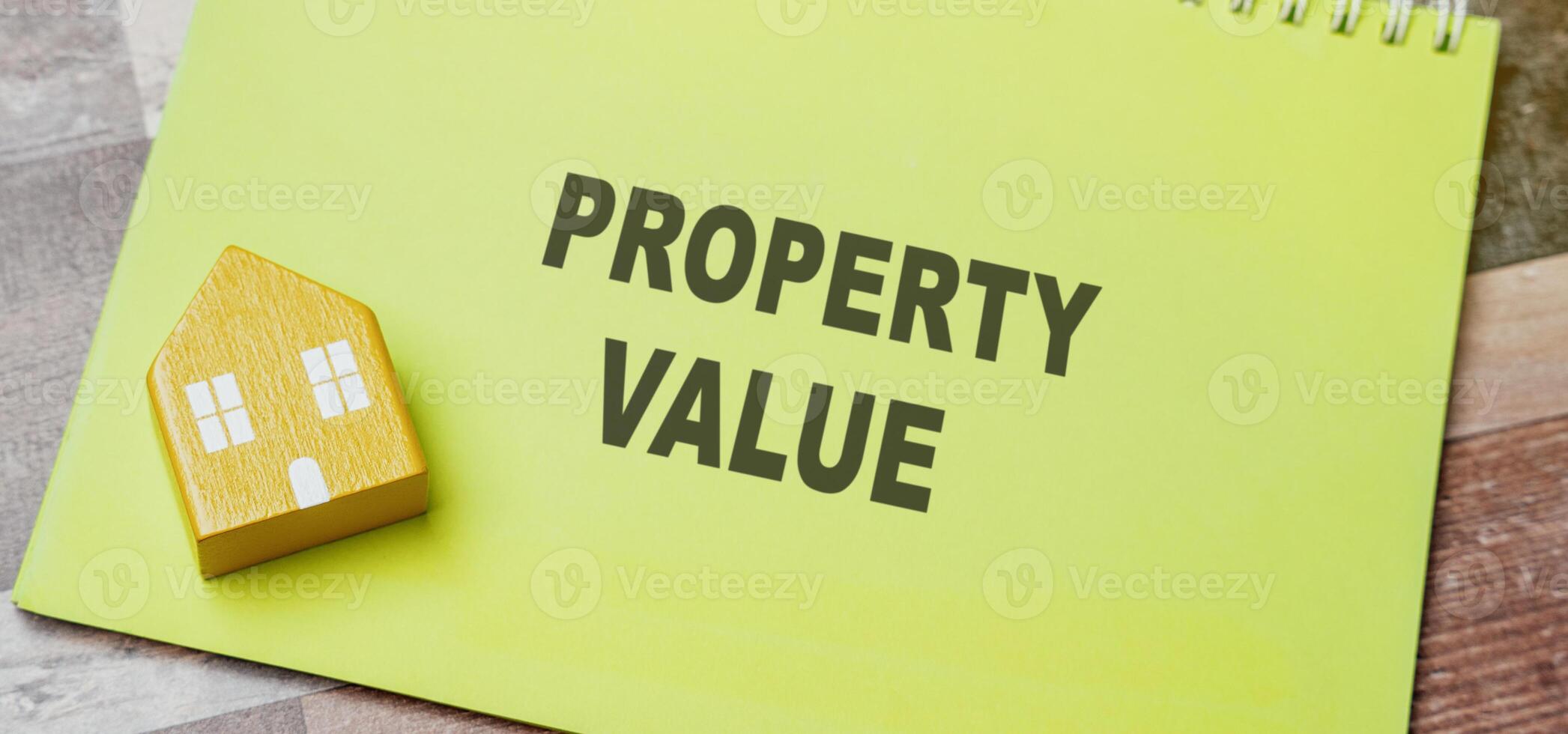 Property value concept. Price a potential buyer is willing to pay. Business, finance and real estate. Home appraisal. A miniature house lies on a notebook with an inscription photo