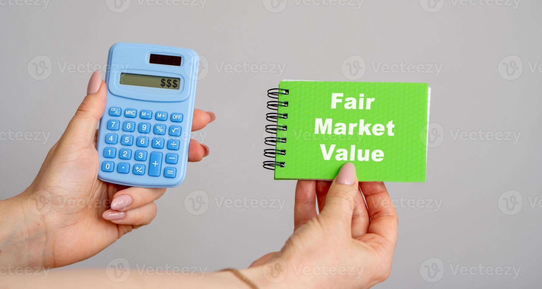 Fair Market Value concept. Price an asset would sell for on the open market when certain conditions are met. Business and finance. Calculator and notebook in hands photo