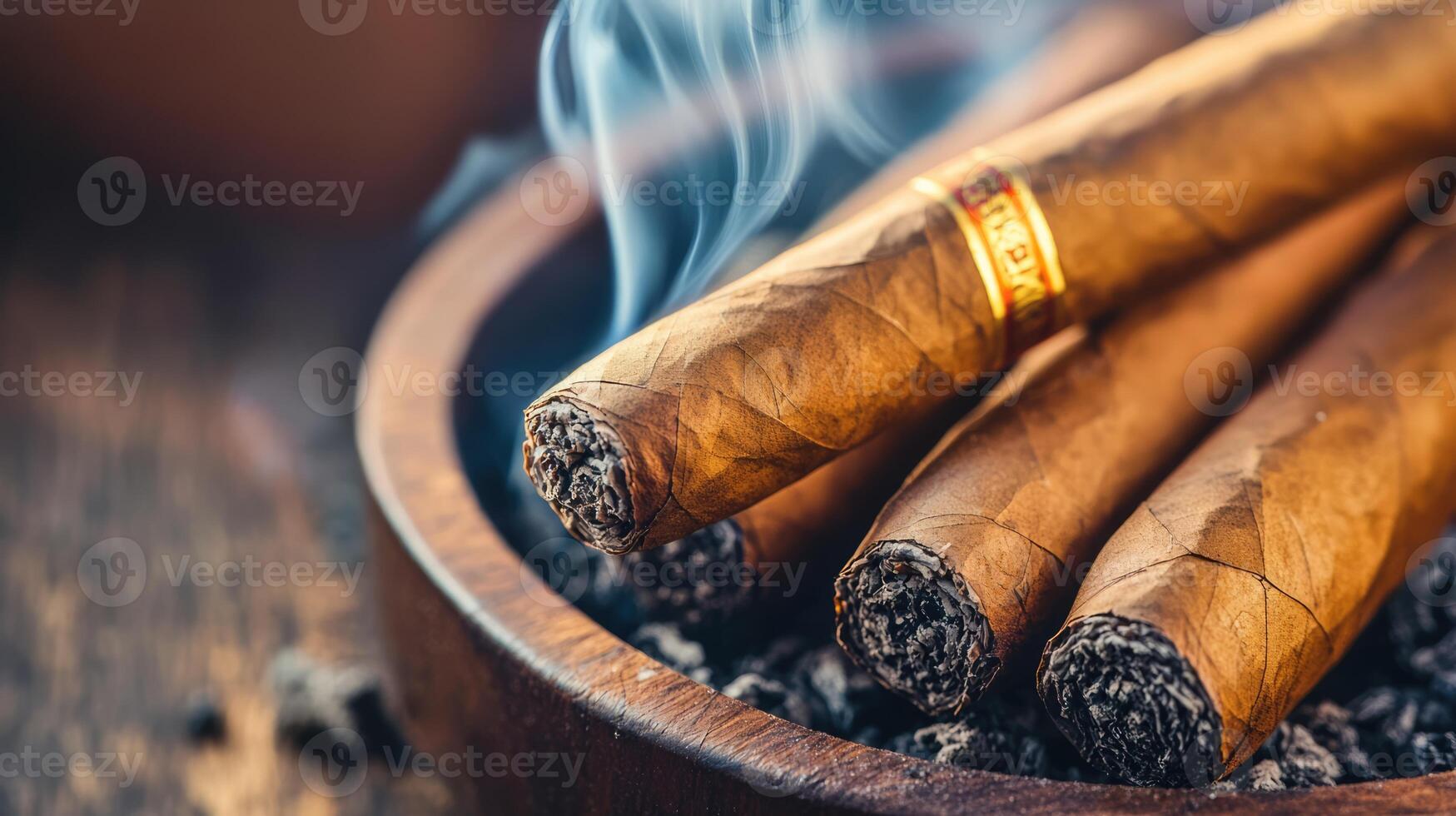 Close-up of expensive smoking Cuban cigars in a brown ashtray. Luxury lifestyle concept photo