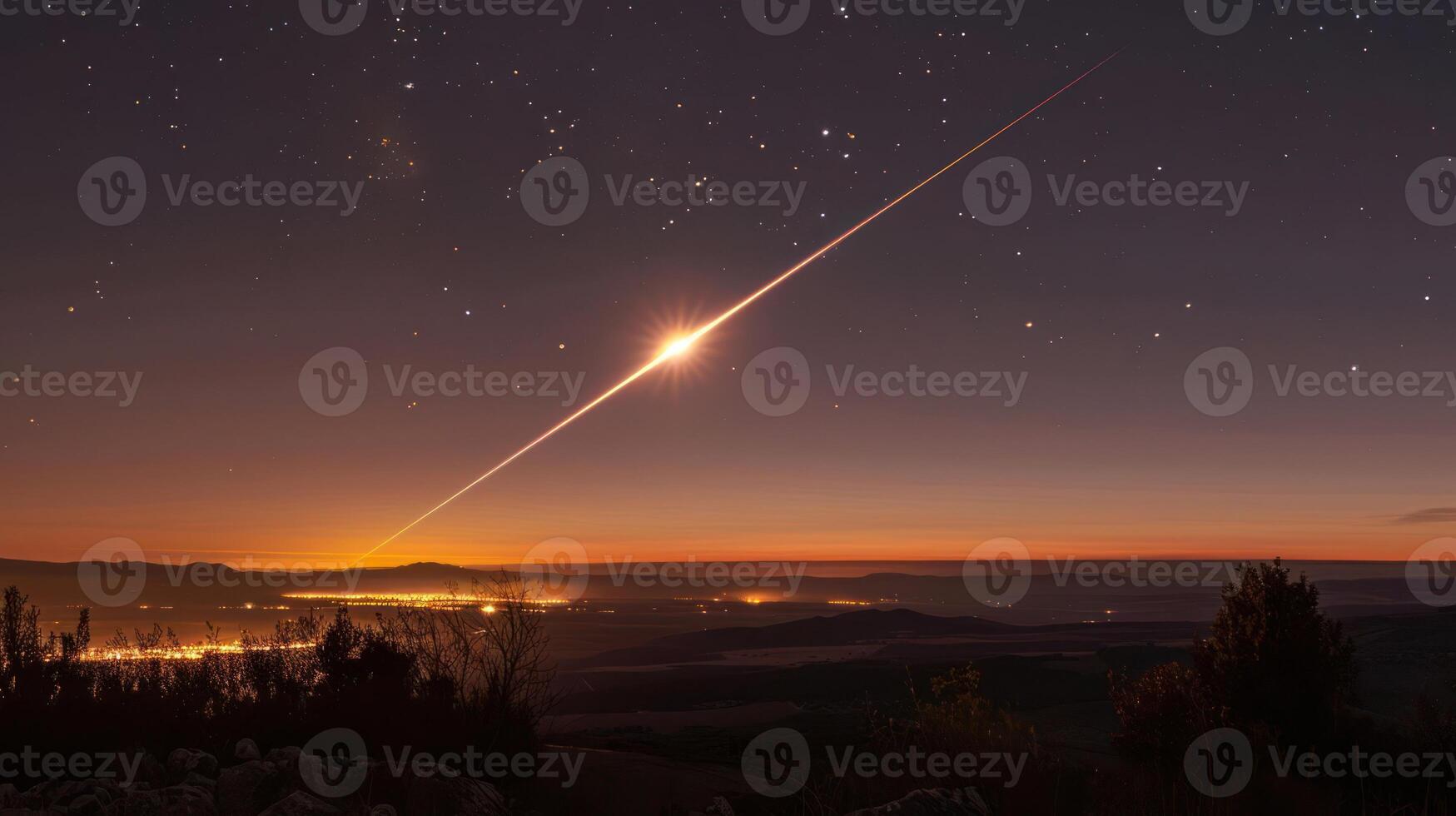Stunning meteor streaks across the night sky over a tranquil landscape with distant city lights photo