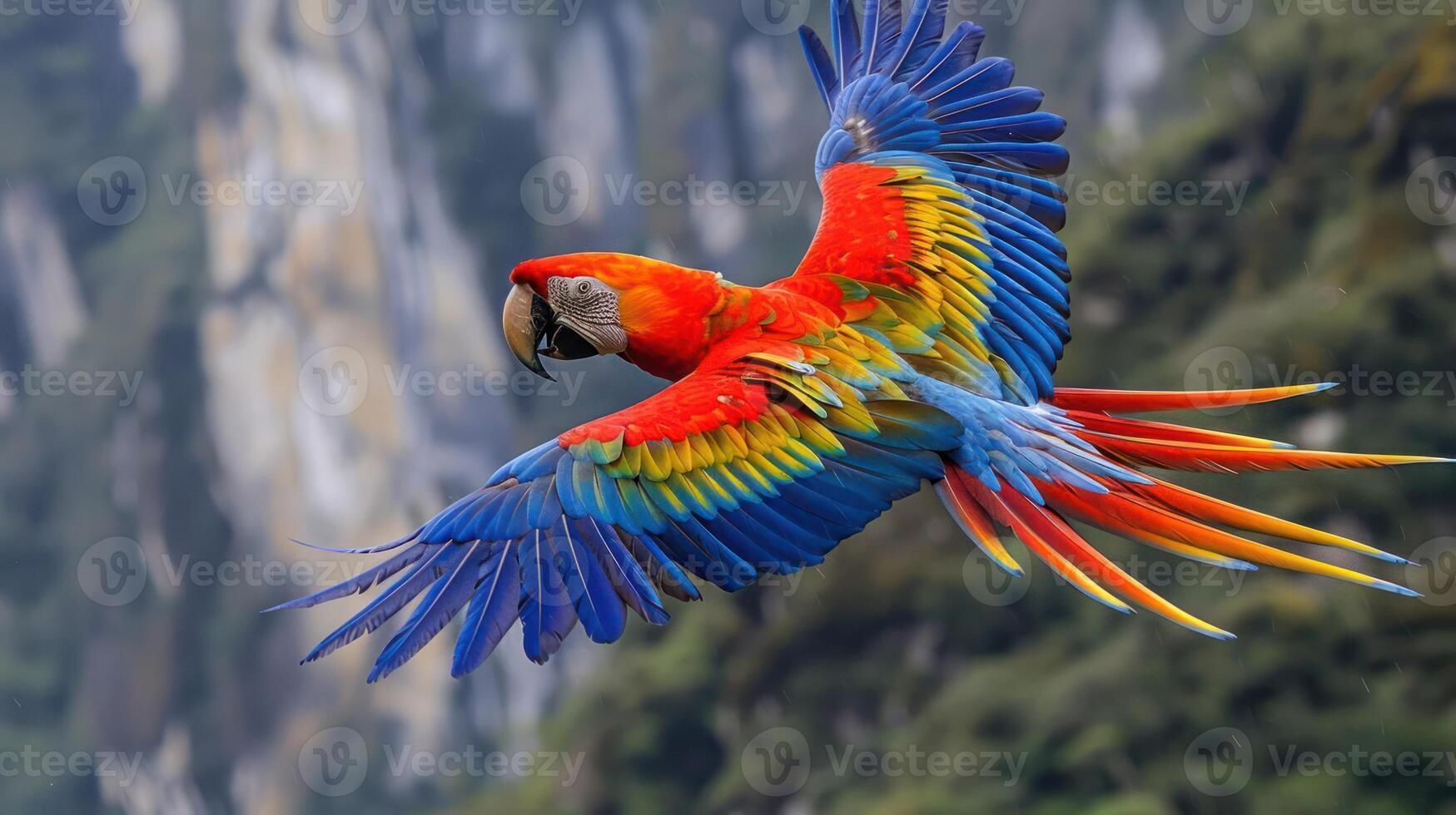 Vibrant Scarlet Macaw in Flight Over Lush Green Mountains with Colorful Feathers Displayed photo