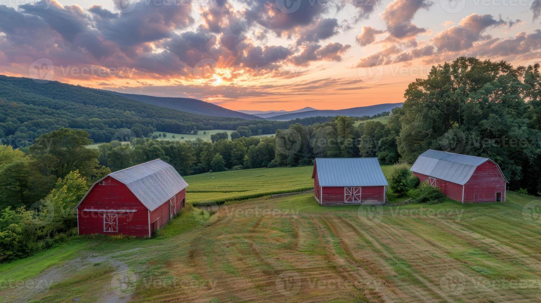 Scenic view of red barns at sunset in a lush valley with rolling hills and dramatic skies photo