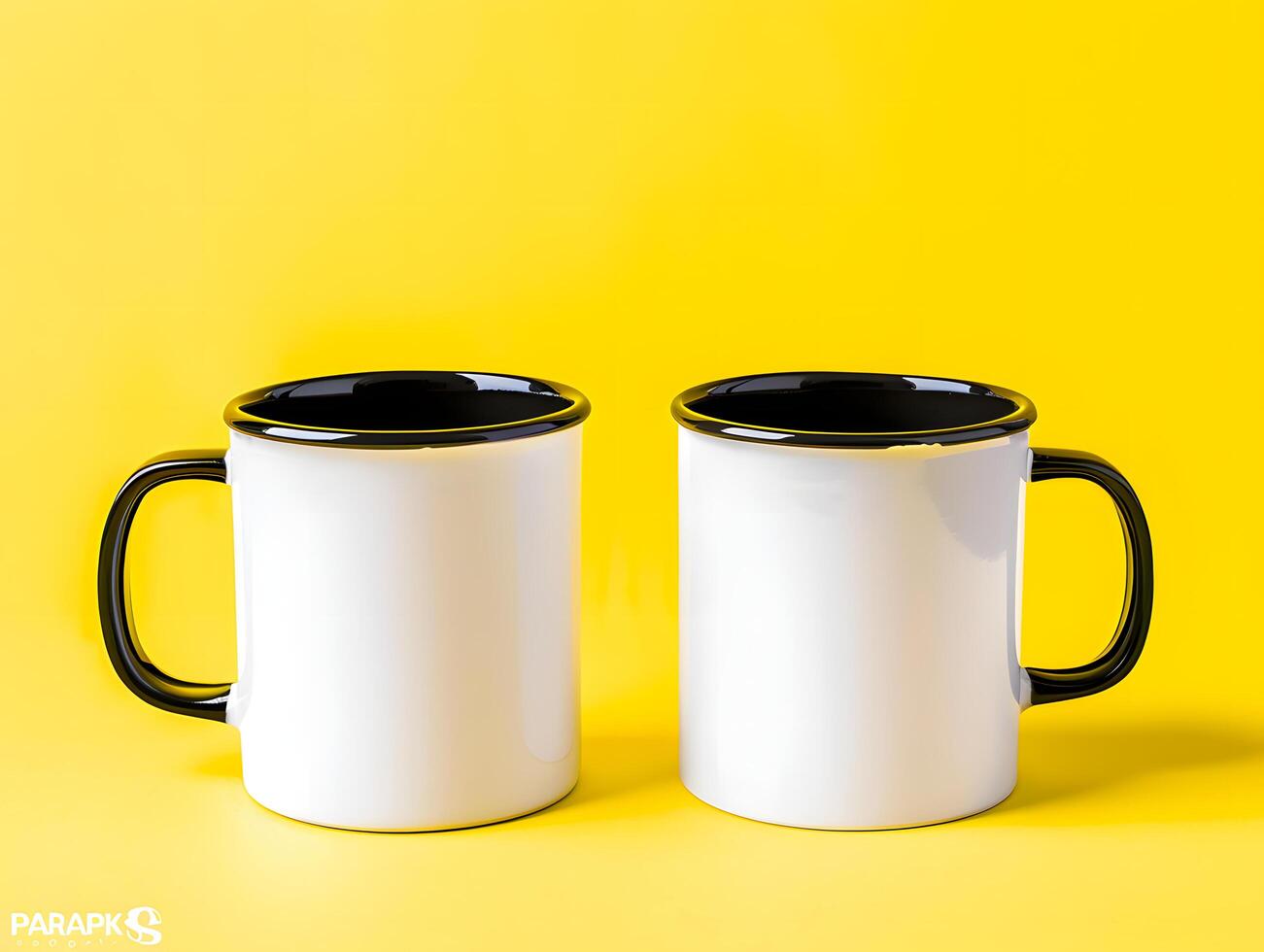 Two white and black coffee mugs on a yellow background photo