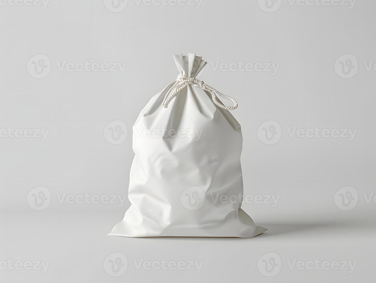 White bag with a drawstring on a plain surface photo