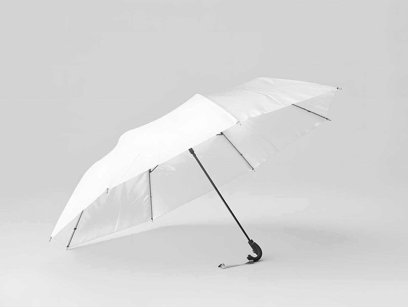 A white umbrella with a black handle on a gray background photo