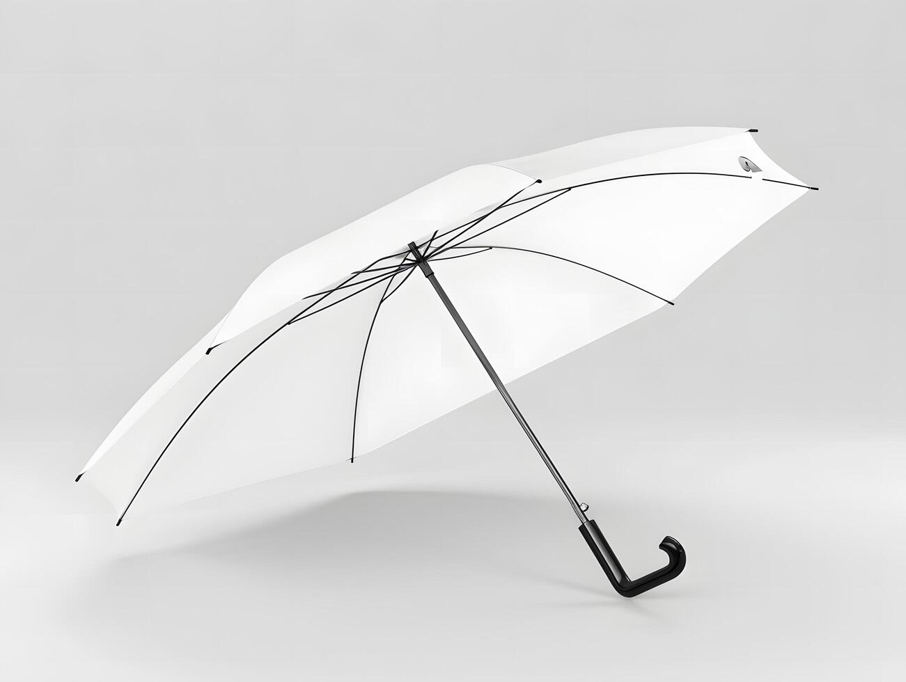 A white umbrella with black handle on a gray background photo
