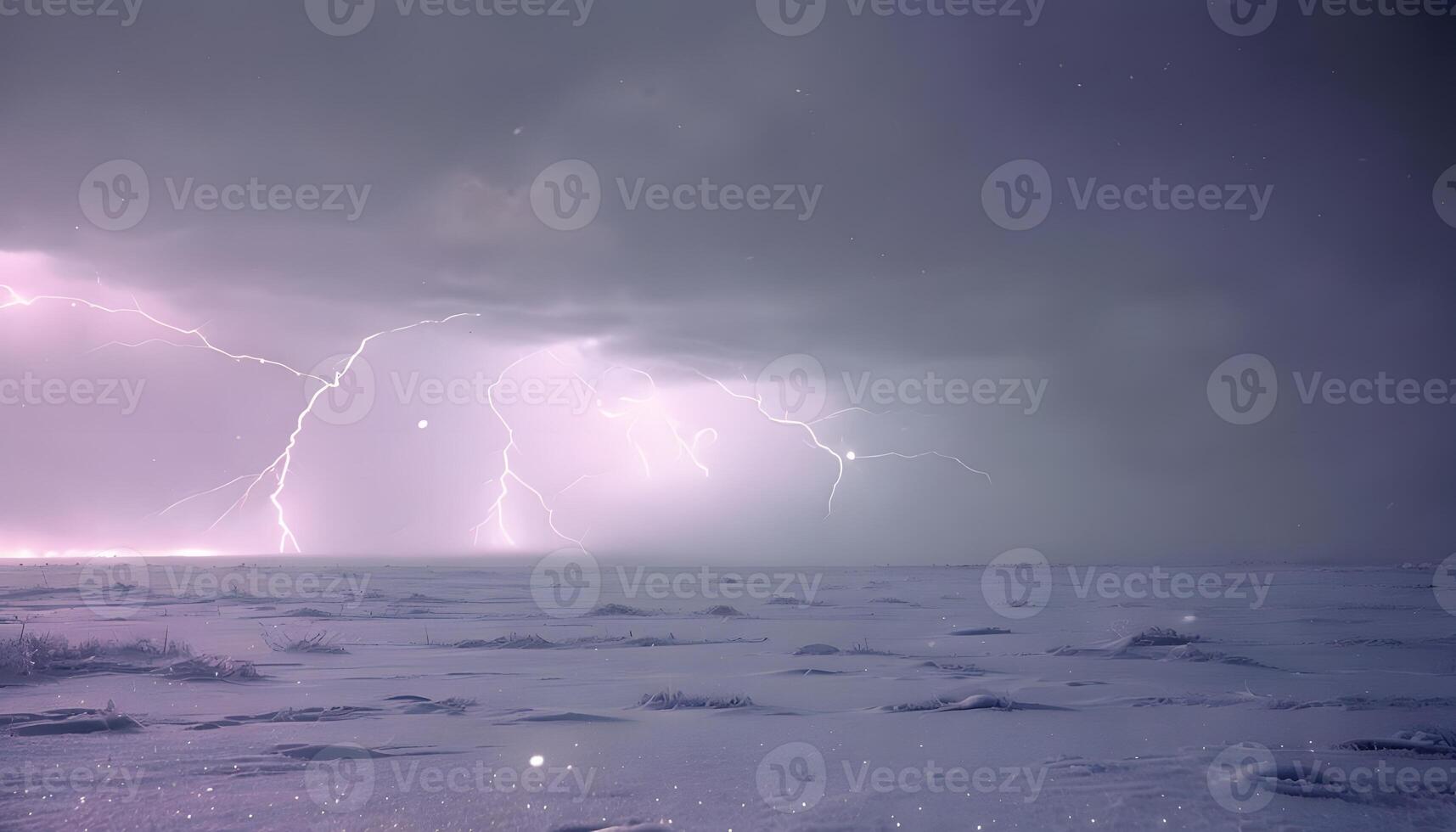 Lightning strikes over a snowy field photo
