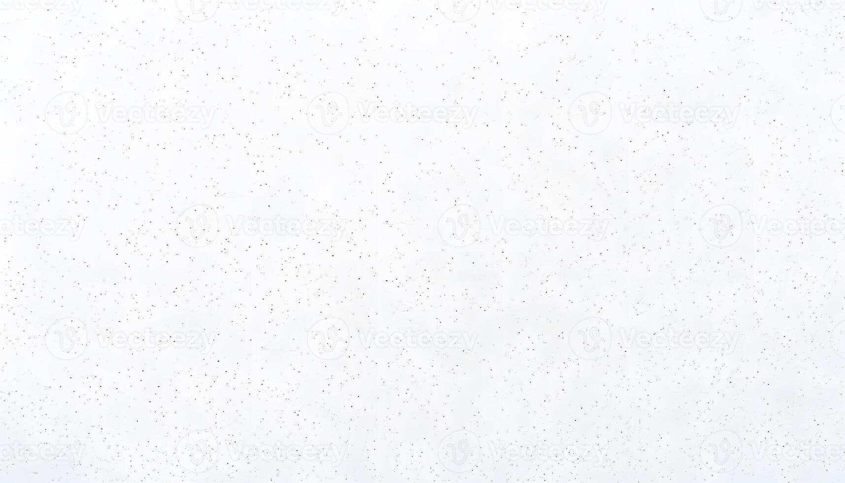 A white wall with a few spots of white paint photo