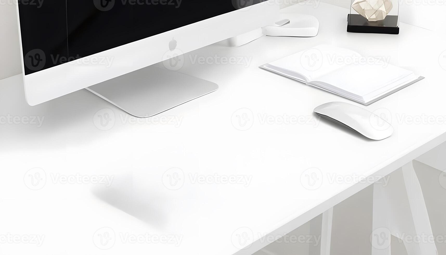 A white desk with a computer, mouse and books photo