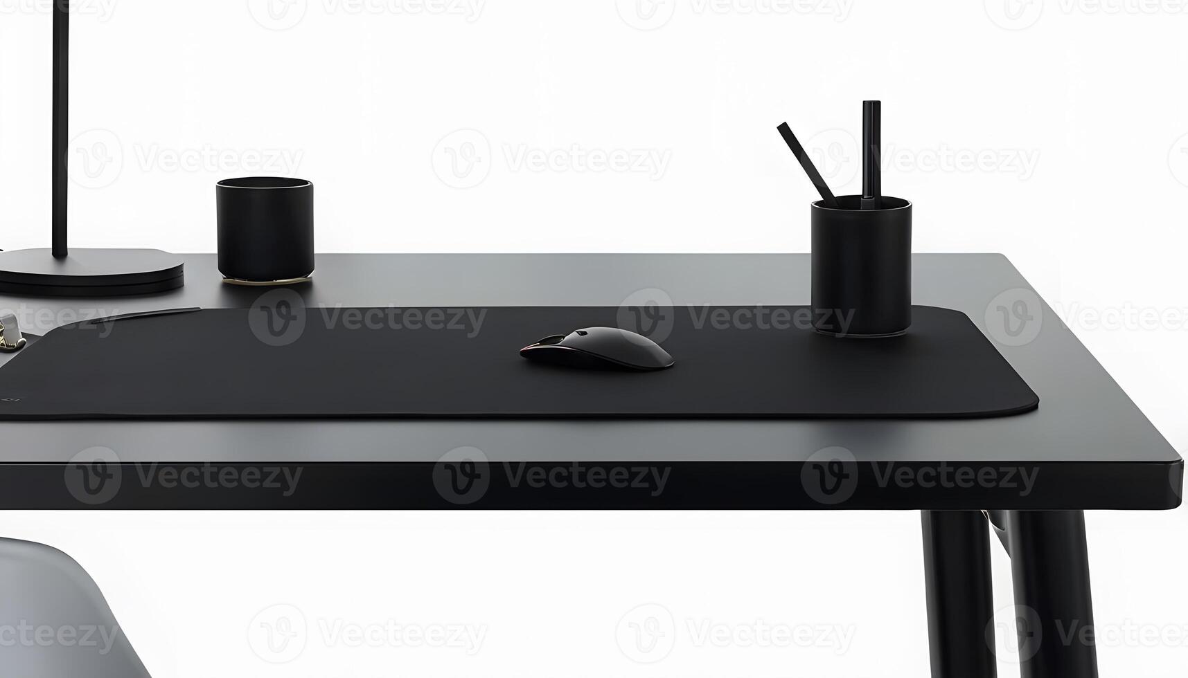 A black desk with a mouse pad and a lamp photo