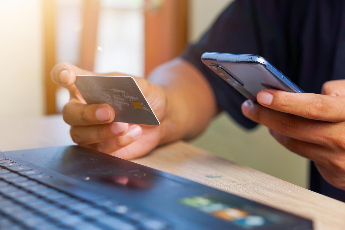 a man using his smartphone to pay for a credit card photo