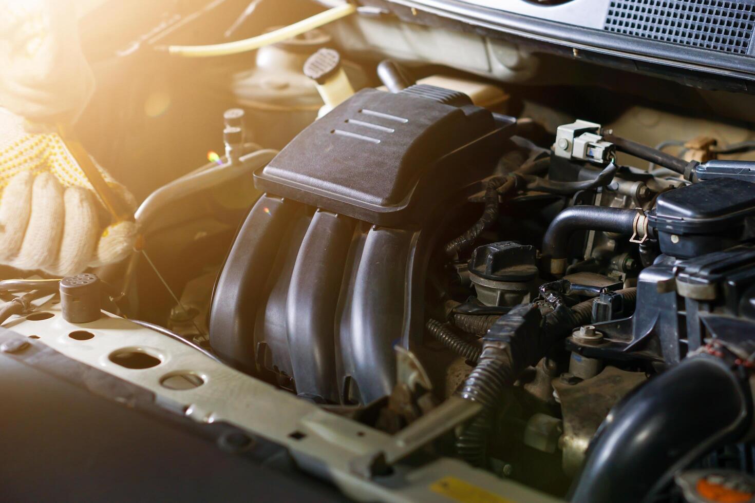 A mechanic inspecting the engine components photo