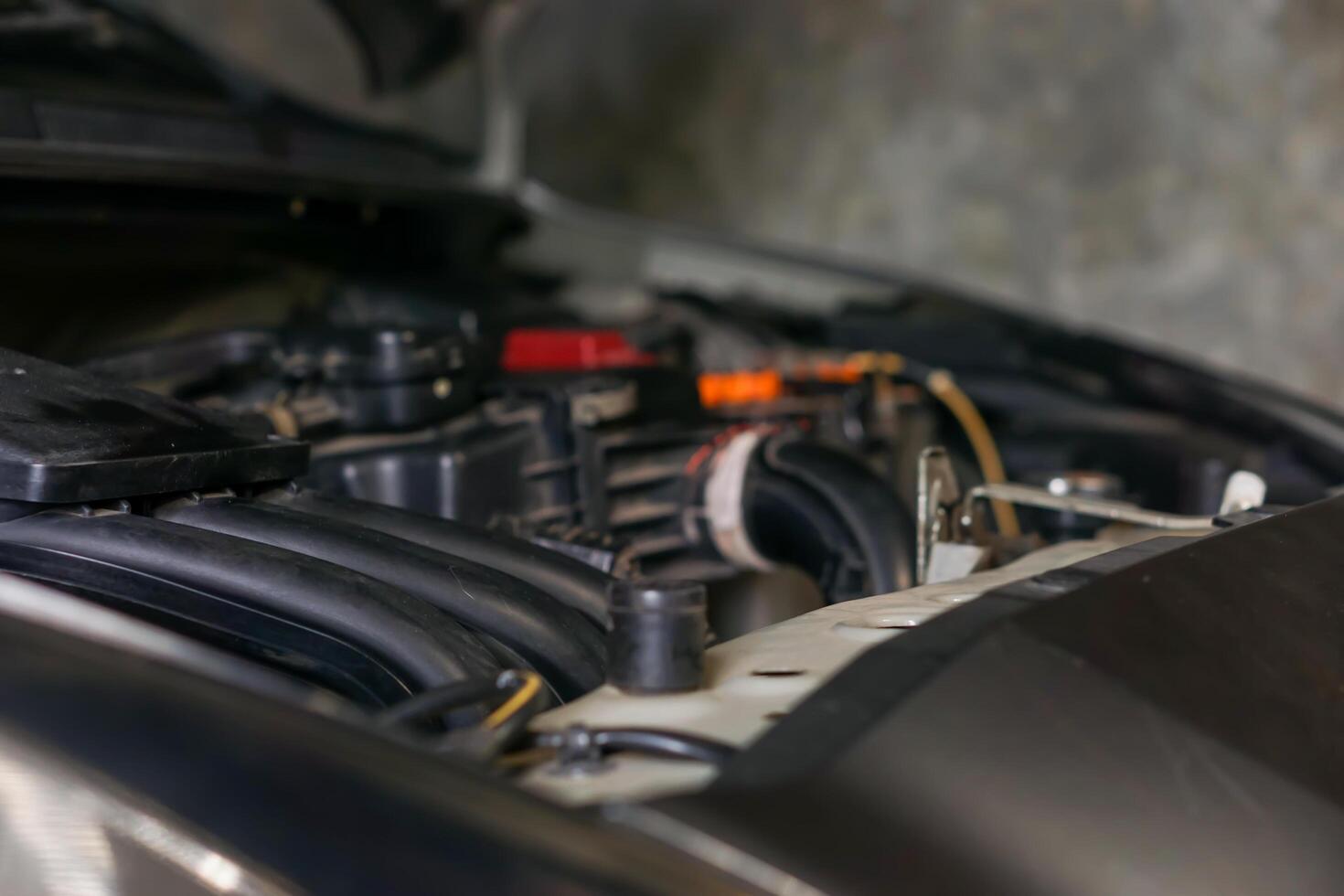 a close up of a car engine with the hood open photo