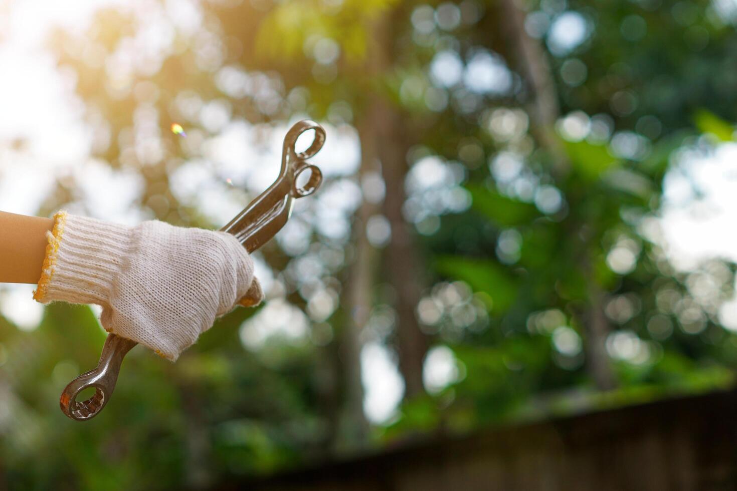 a person holding a pair of scissors in their hand photo