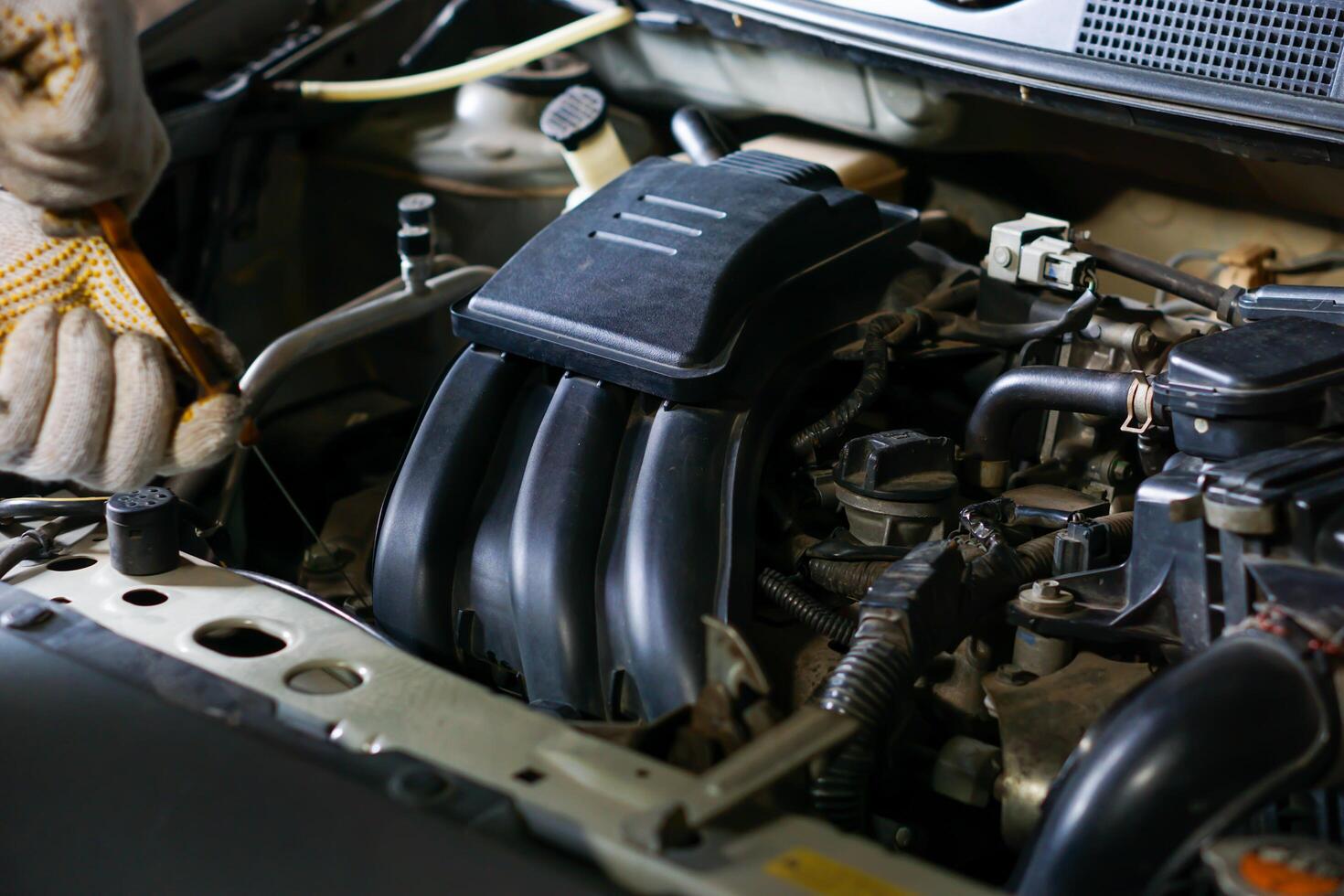 a man is working on a car engine photo