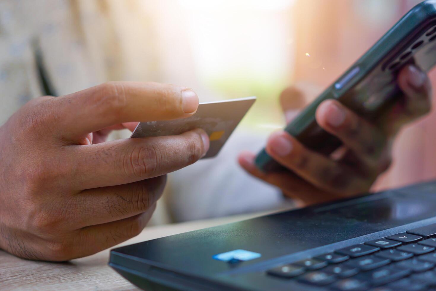 man using credit card and laptop photo