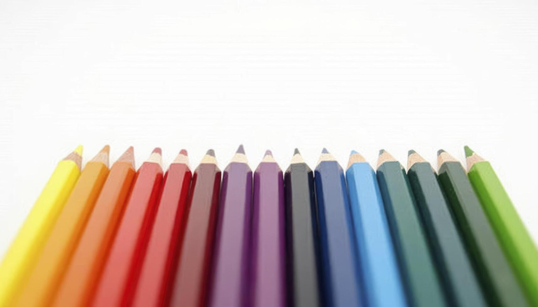 A set of colored pencils arranged in a perfect gradient from light to dark photo